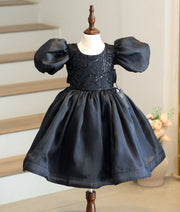 Front view of black organza birthday frock for baby girls featuring a sequin-embellished fancy top