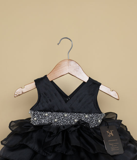 Close-up of the black bodice showing the pleated design and sparkling silver-toned rhinestone waistband