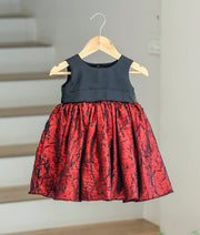 Front view of a black and red shimmer crush organza birthday frock for baby girls.