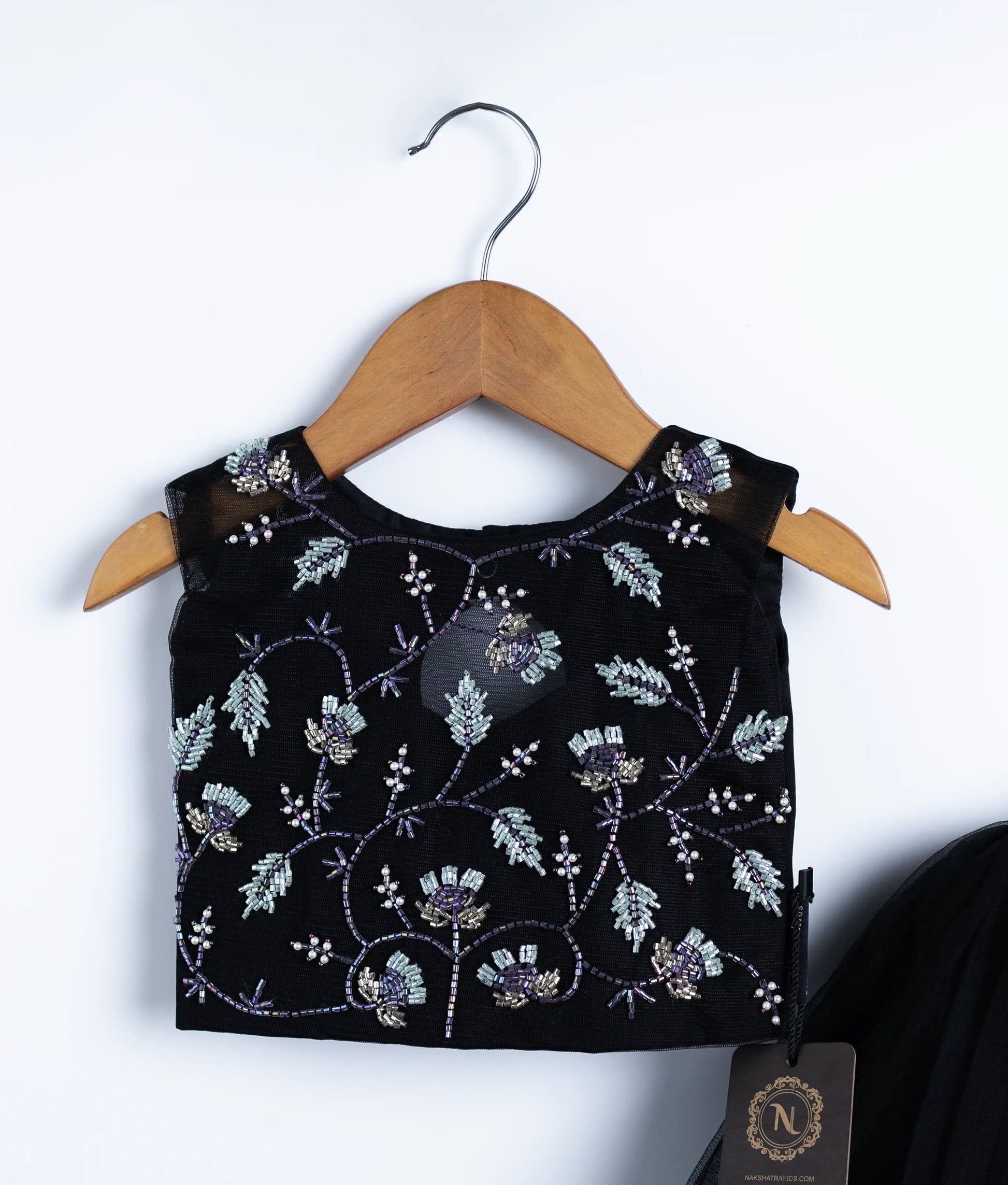 Close-up of black swan theme embroidered top showing handmade applique work in skirt and top set for baby girl