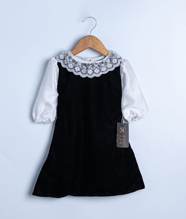 Black velvet A-line skirt and below-knee length, ideal for holiday occasions.