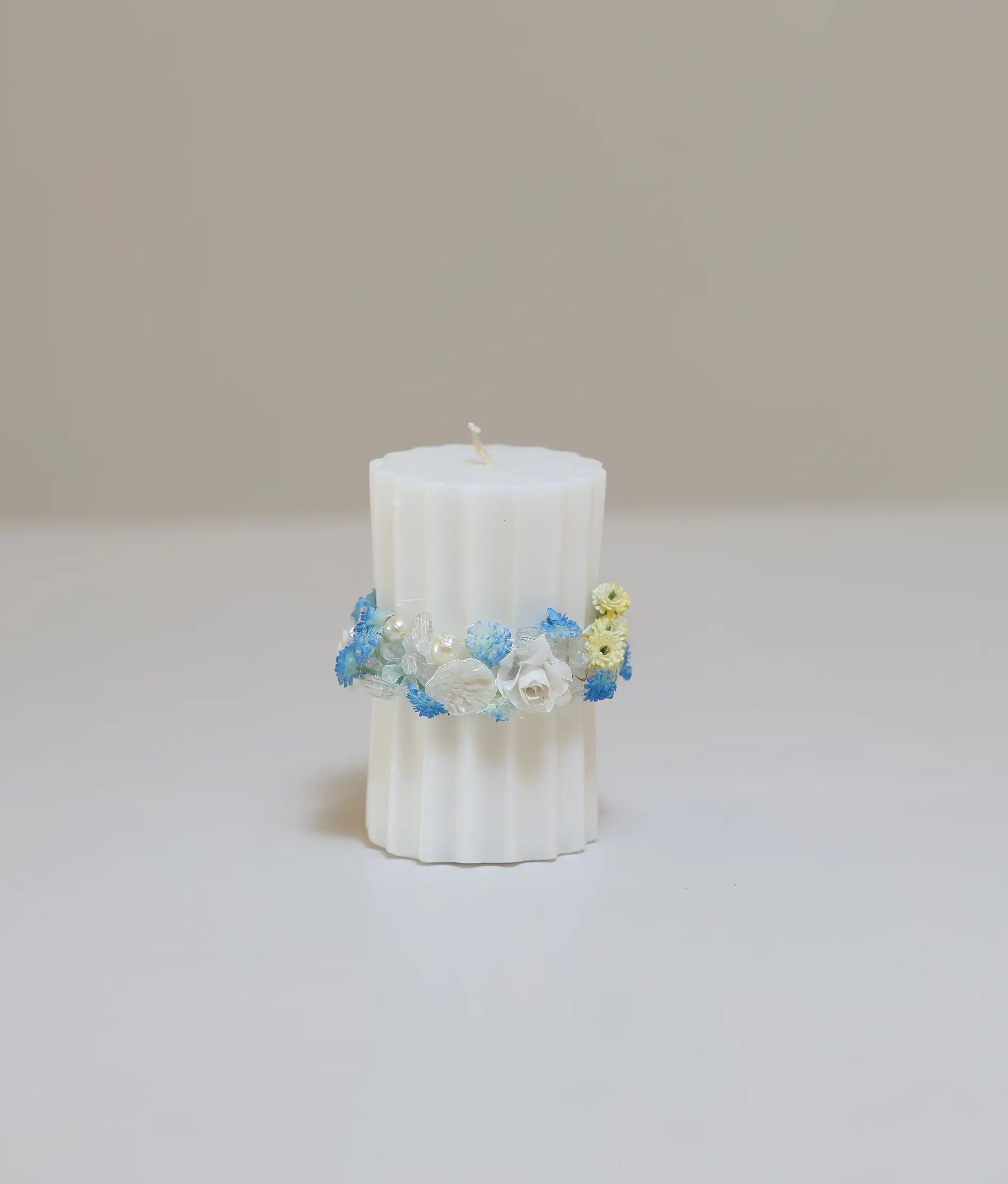 Blue and yellow floral pillar baptism candle for baby with handcrafted flower band and iridescent beads