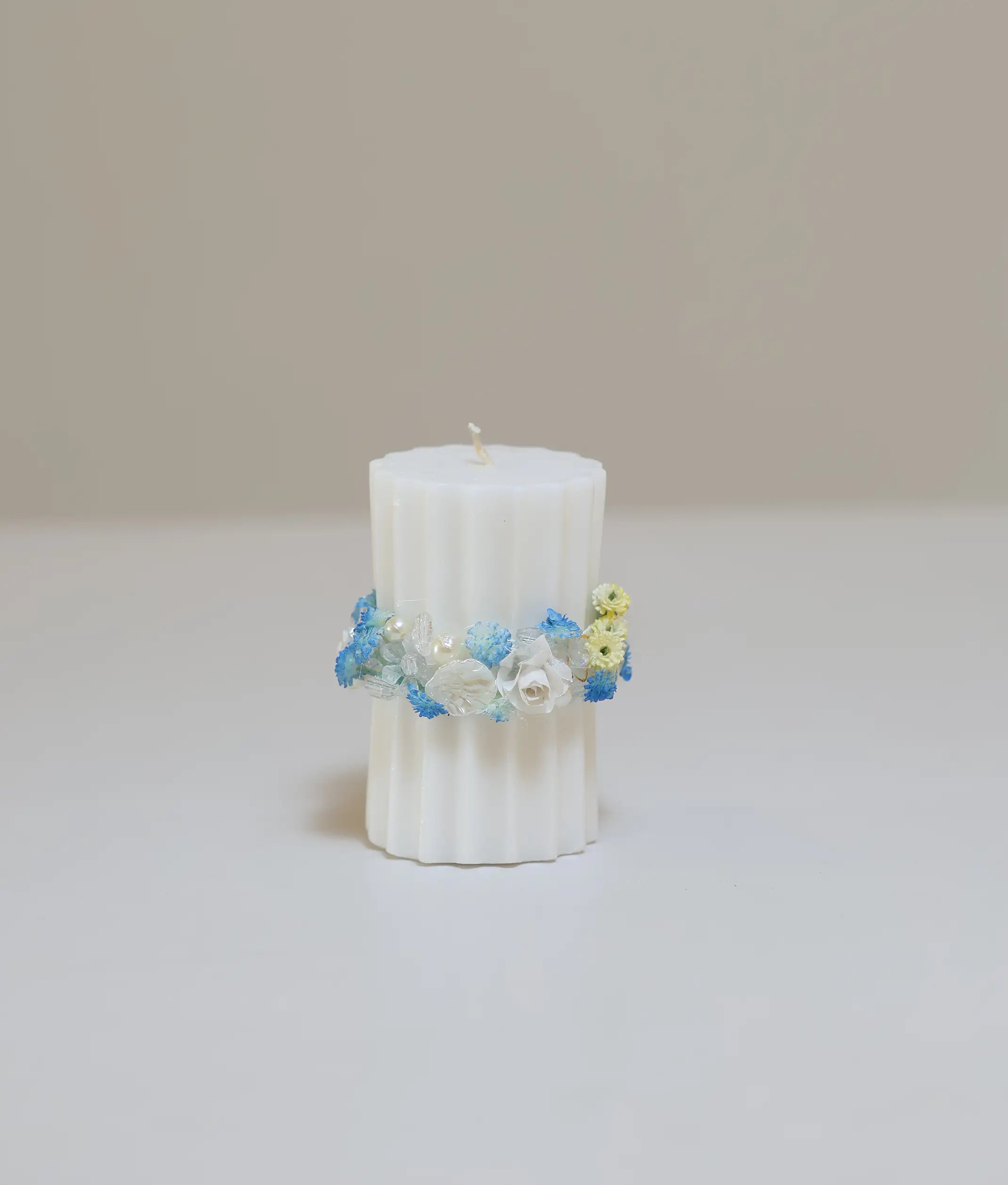 Blue and yellow floral pillar baptism candle for baby with handcrafted flower band and iridescent beads