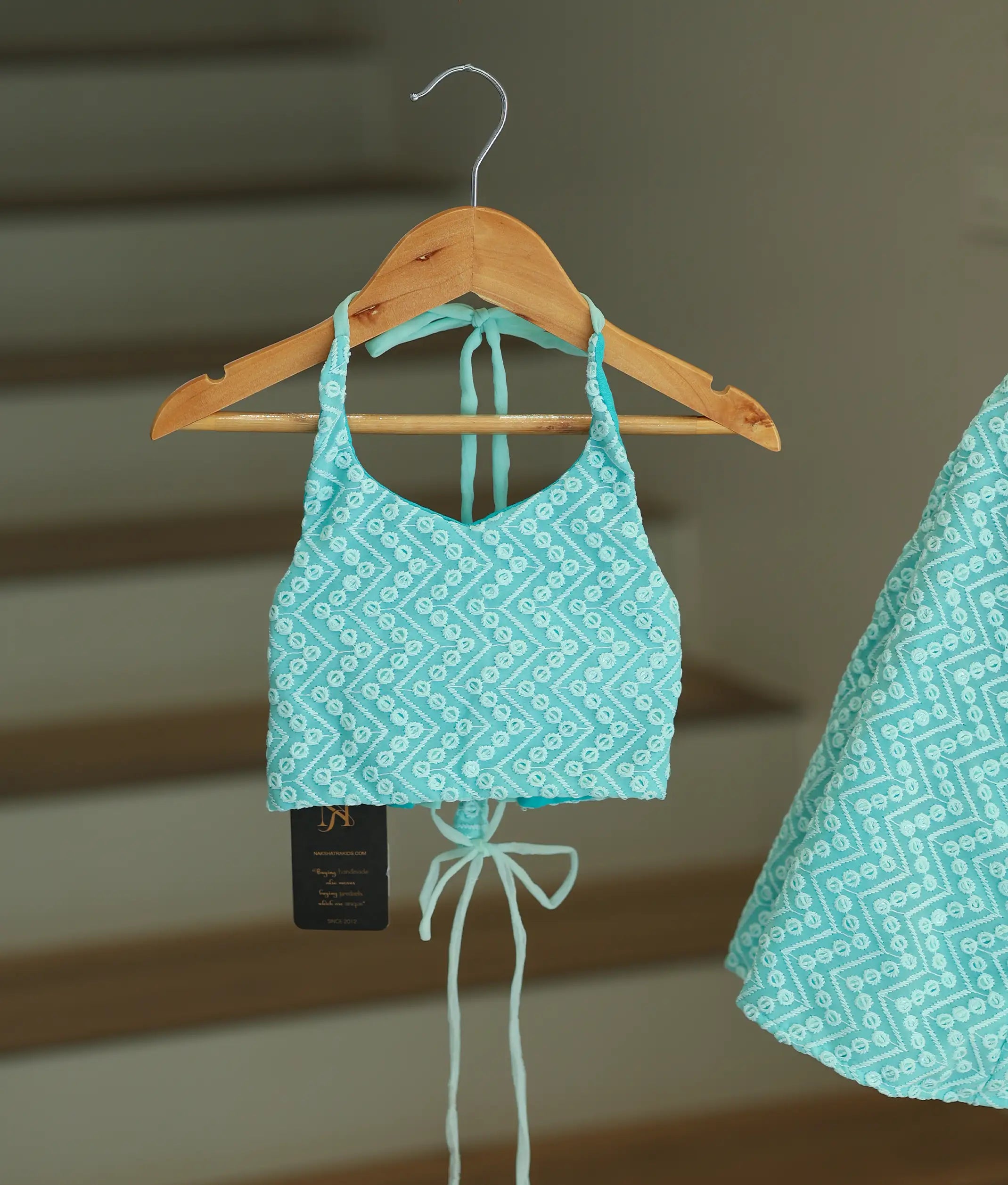 Close-up of the occasion blue georgette top showing the halter neck and adjustable tie details