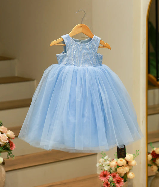 Full front view of a long blue tulle net gown with a hand-embroidered beaded yoke and voluminous skirt.