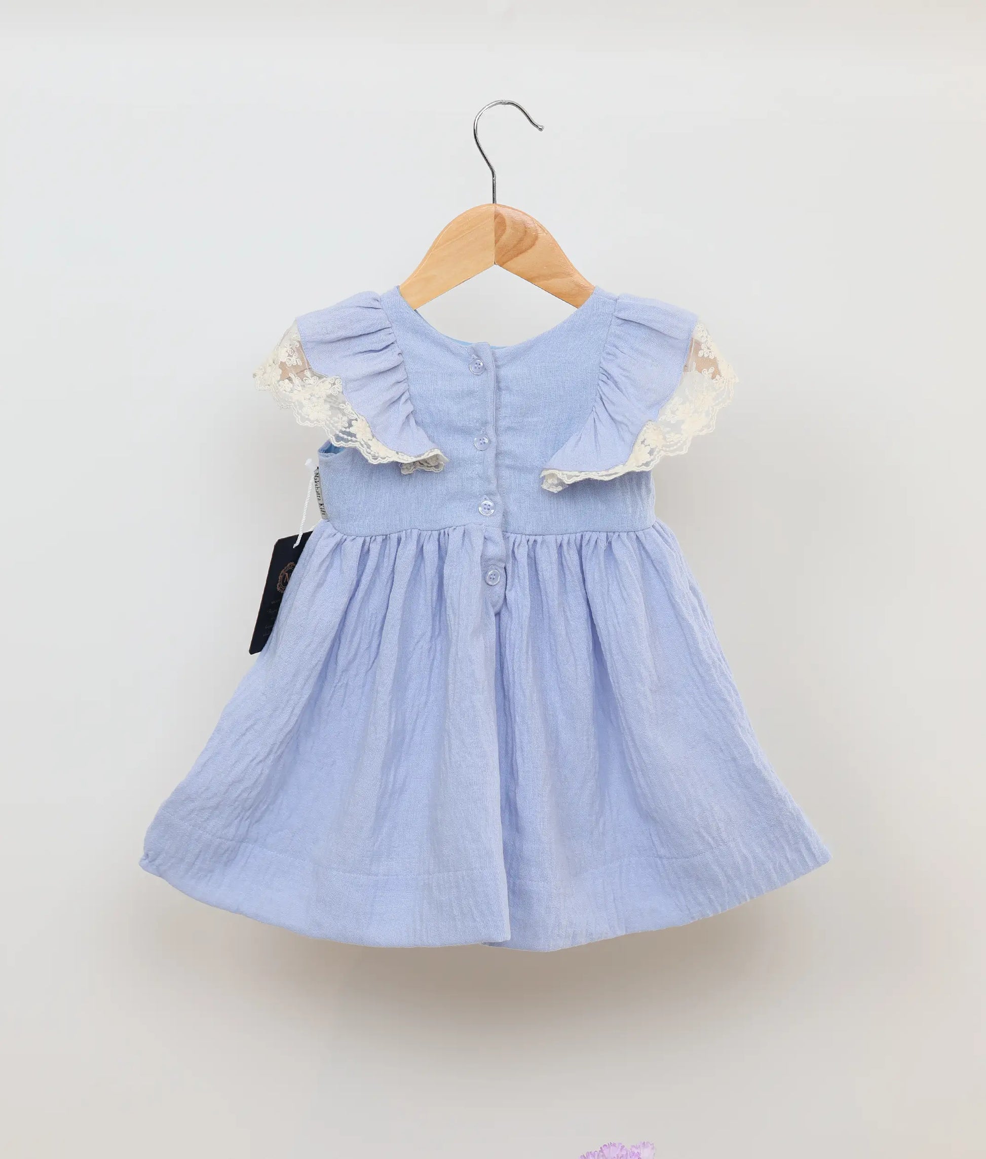 Back view of an blue linen christmas frock for baby girl.