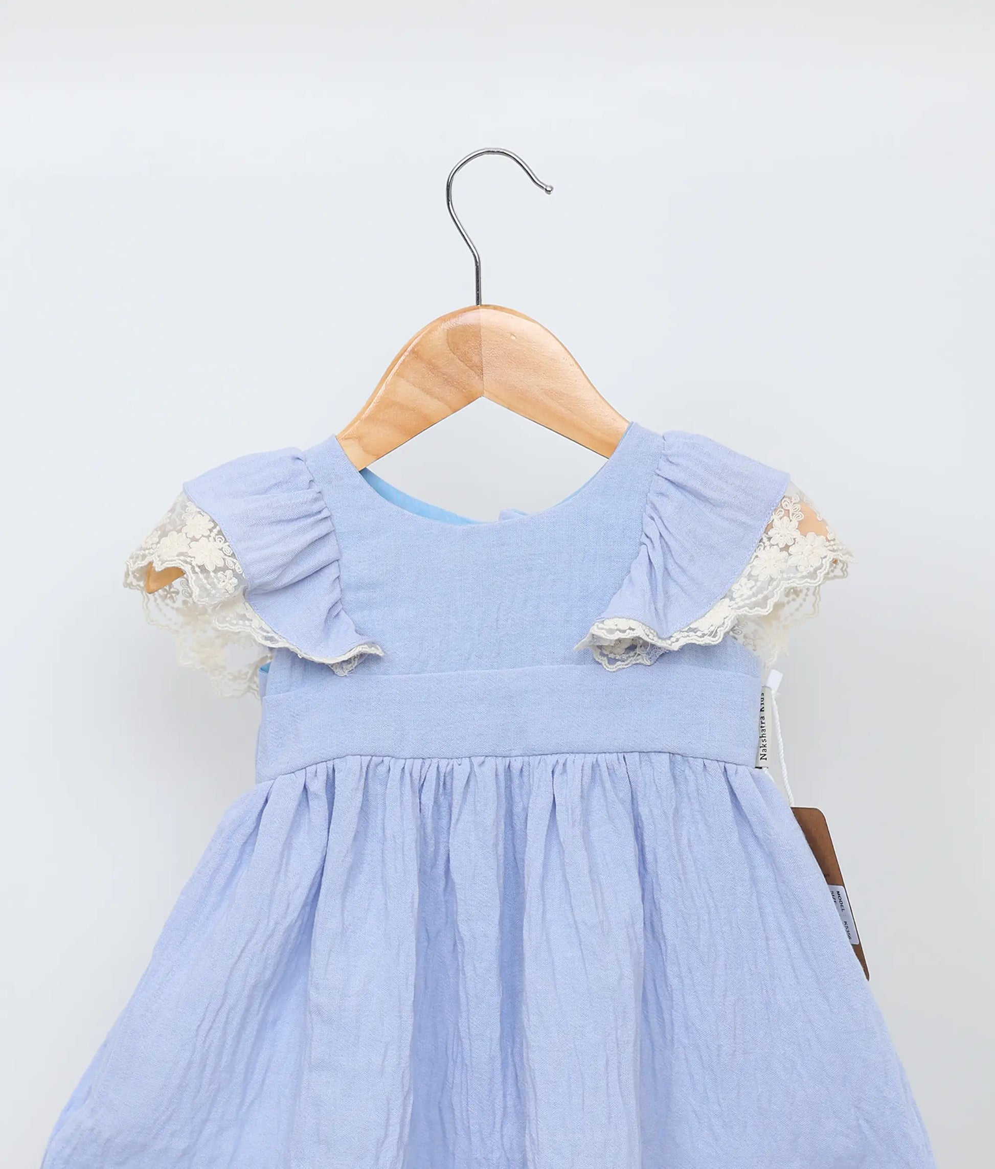 Close view of an blue linen christmas frock for baby girls.