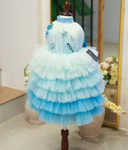 Front view of a blue mermaid theme birthday frock for baby girls with sea creature applique and ruffled skirt