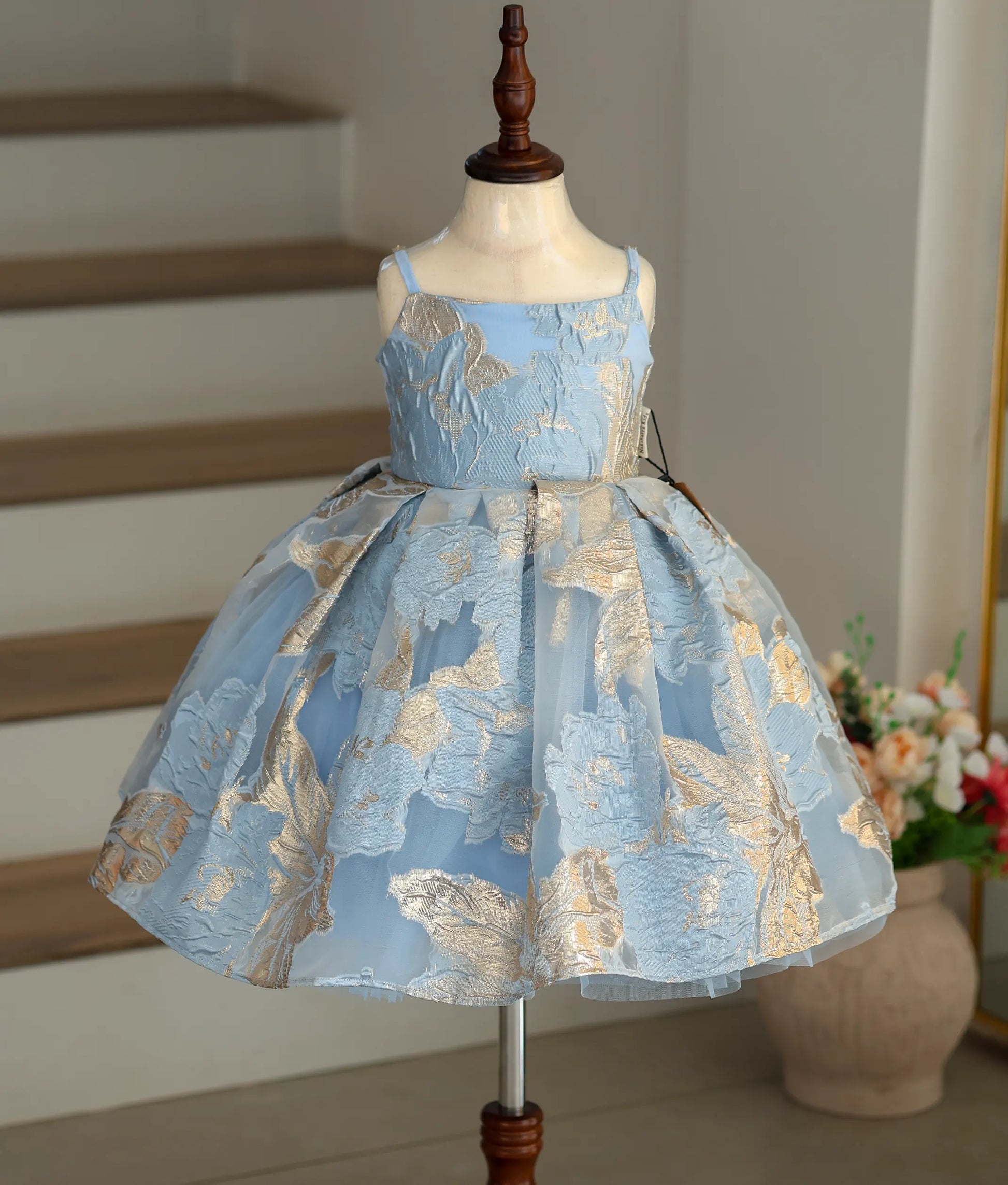 Front view of the blue Turkish organza frock with gold floral patterns and box pleats.