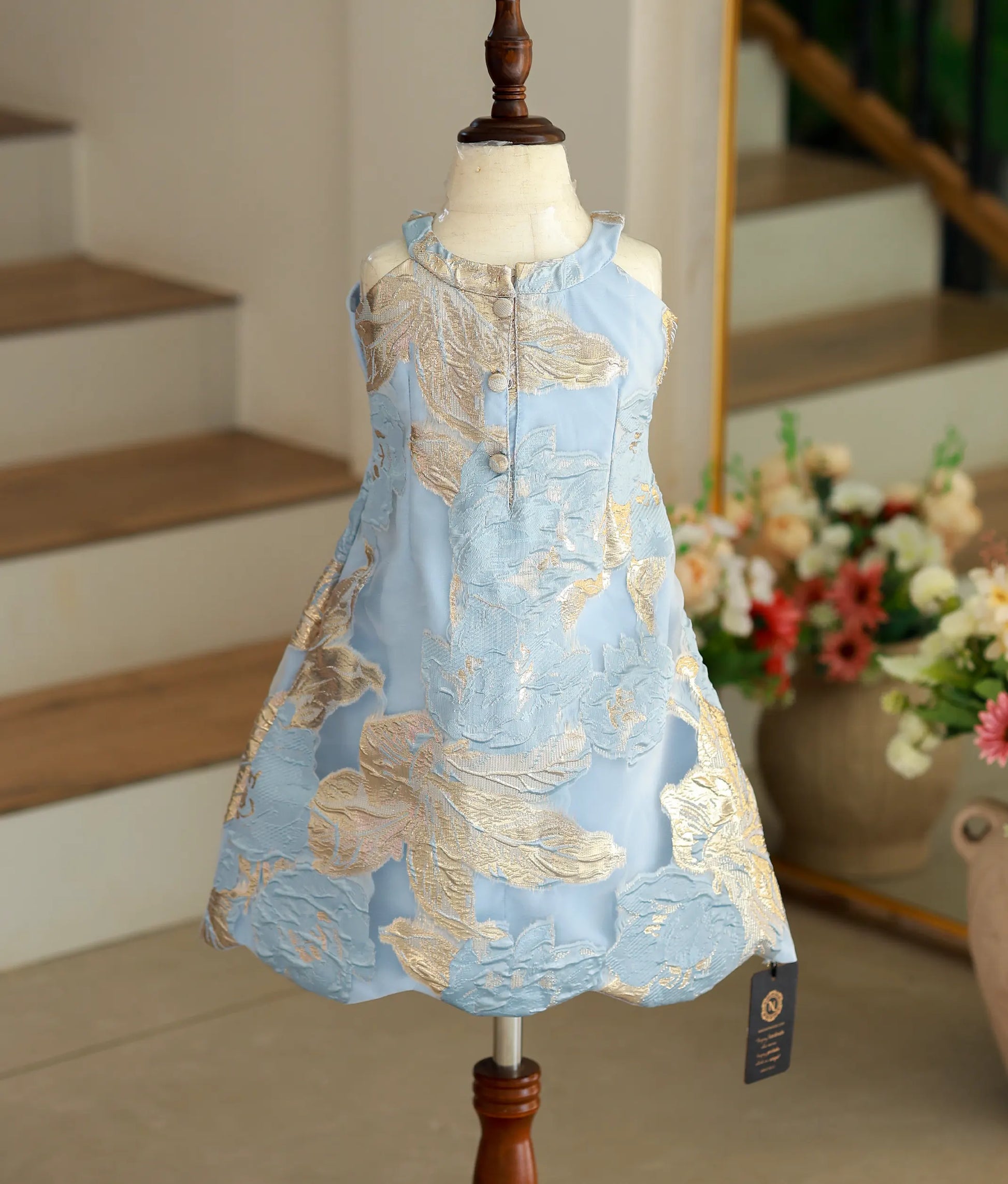 Back view of the blue Turkish organza frock showing the high-neck with button closure and the smooth A-line finish.