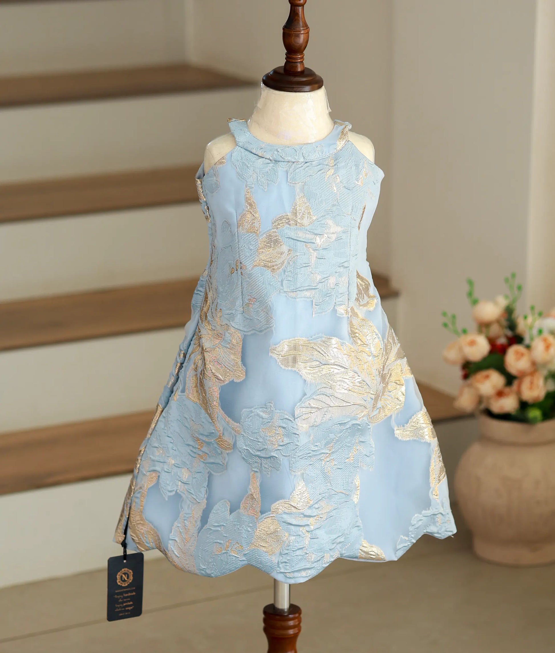 Front view of the blue and gold Turkish organza A-line frock with a high-neck halter design.