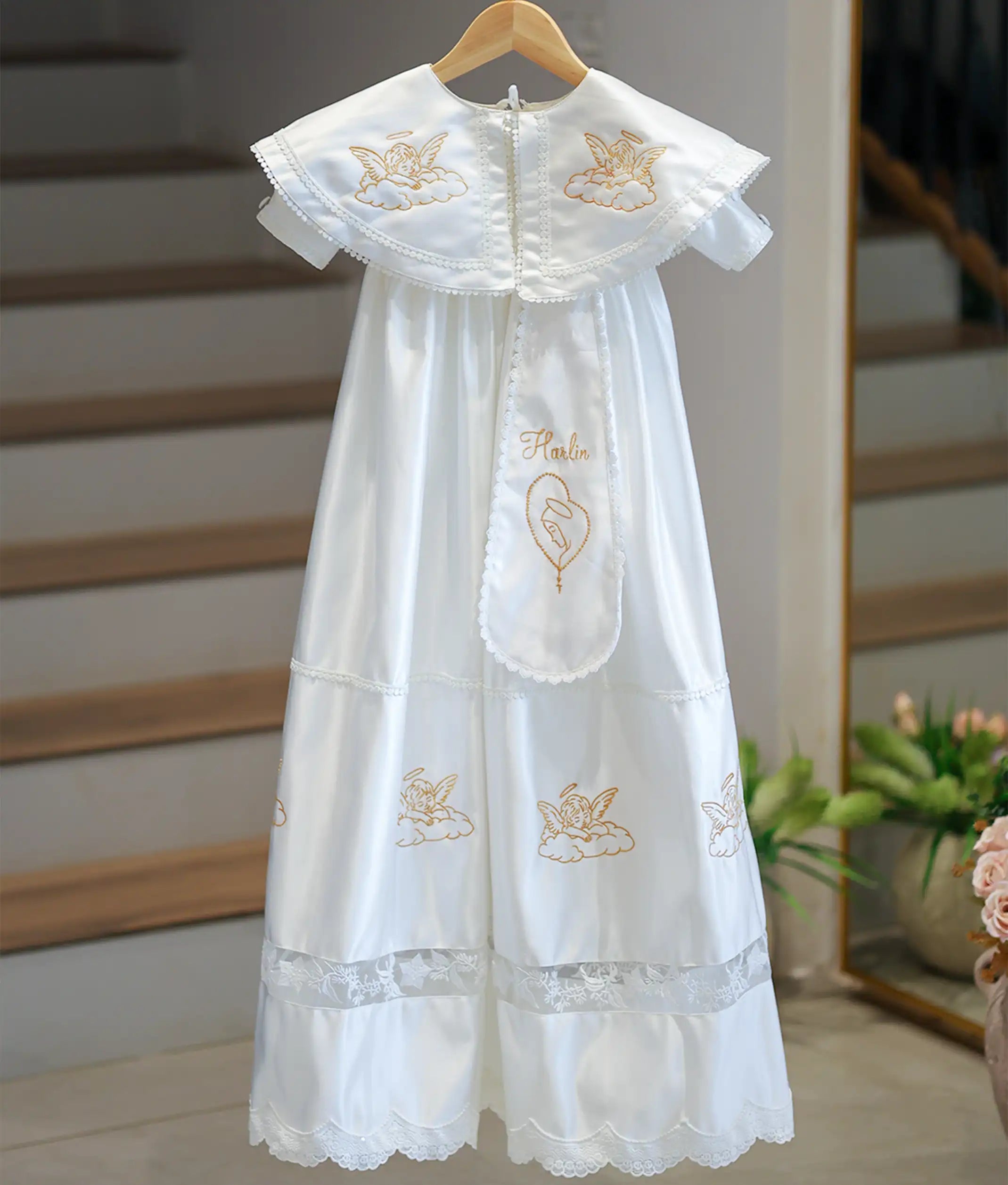 Front view of an off-white satin boys' baptism gown with a large collar and golden embroidery.