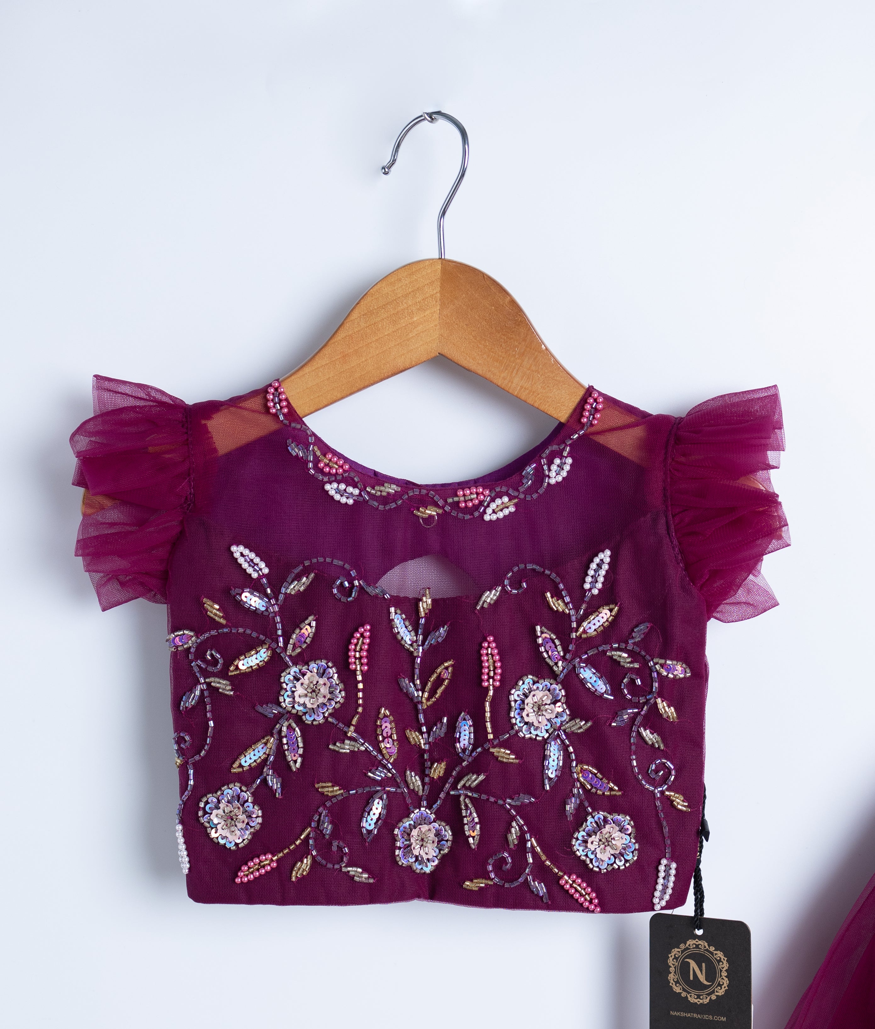Front view of burgundy sequin bodice formal dress with tulle skirt on hanger