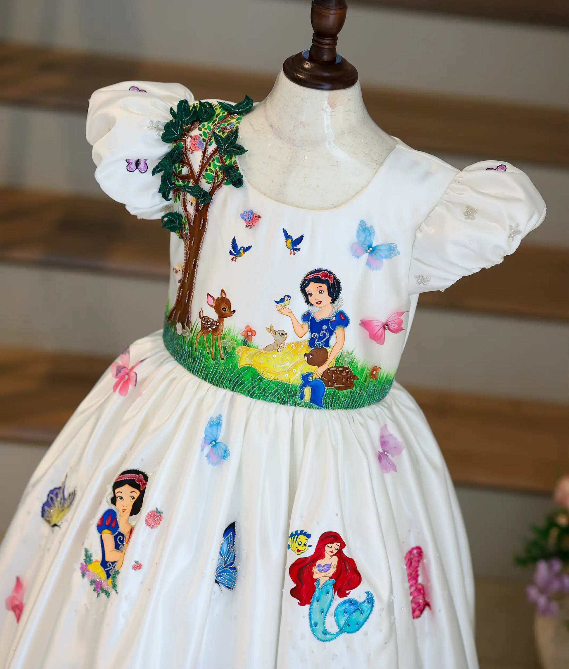 Close-up of the Disney princess-themed gown top showing a 3D beaded tree and Snow White embroidery.