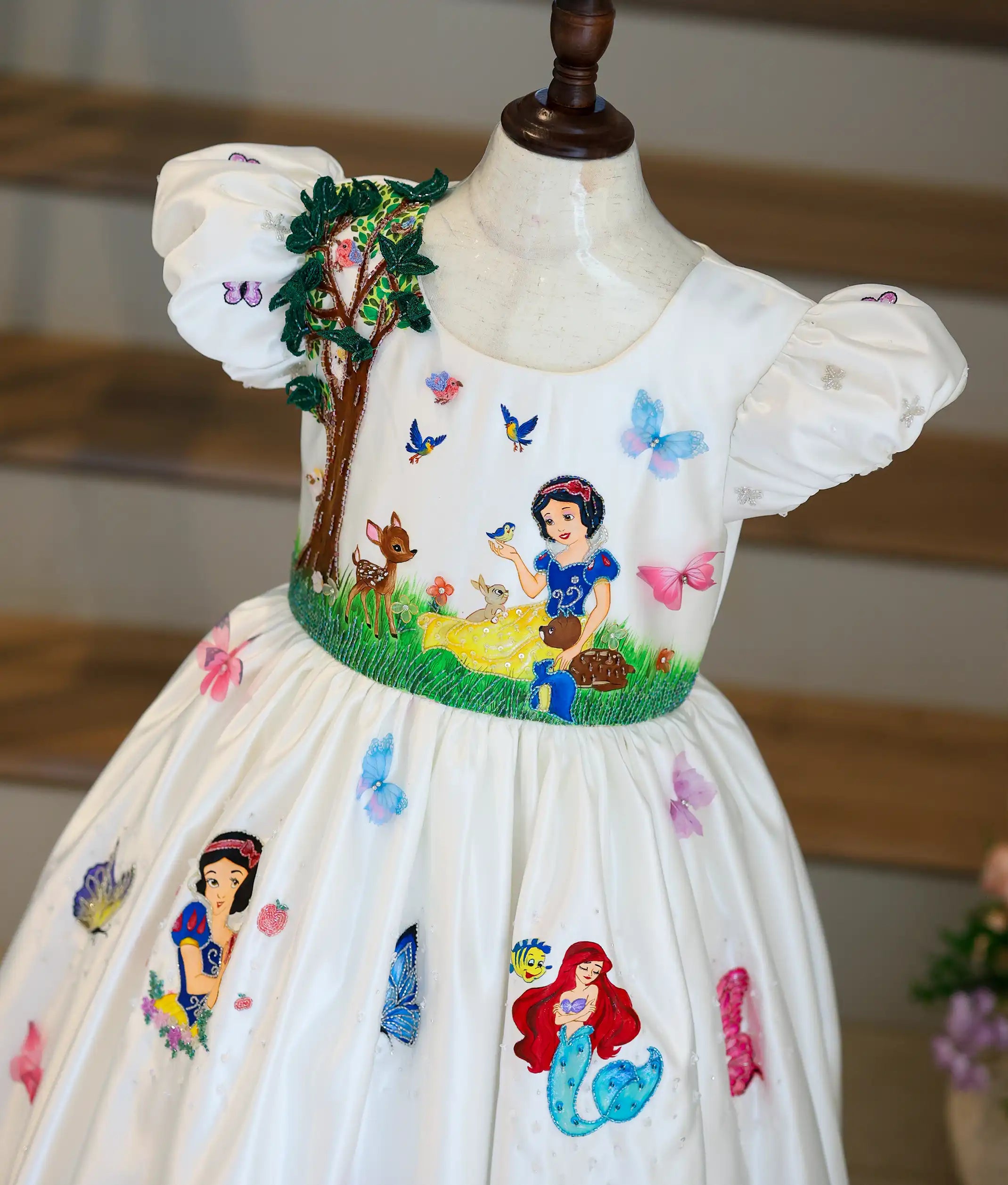 Close-up of the Disney princess-themed gown top showing a 3D beaded tree and Snow White embroidery.