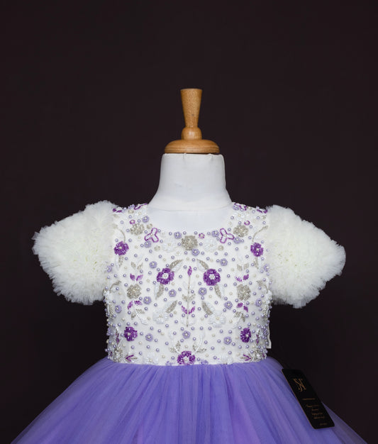 Front view of embroidered formal dress with white bodice featuring purple floral embroidery and purple skirt
