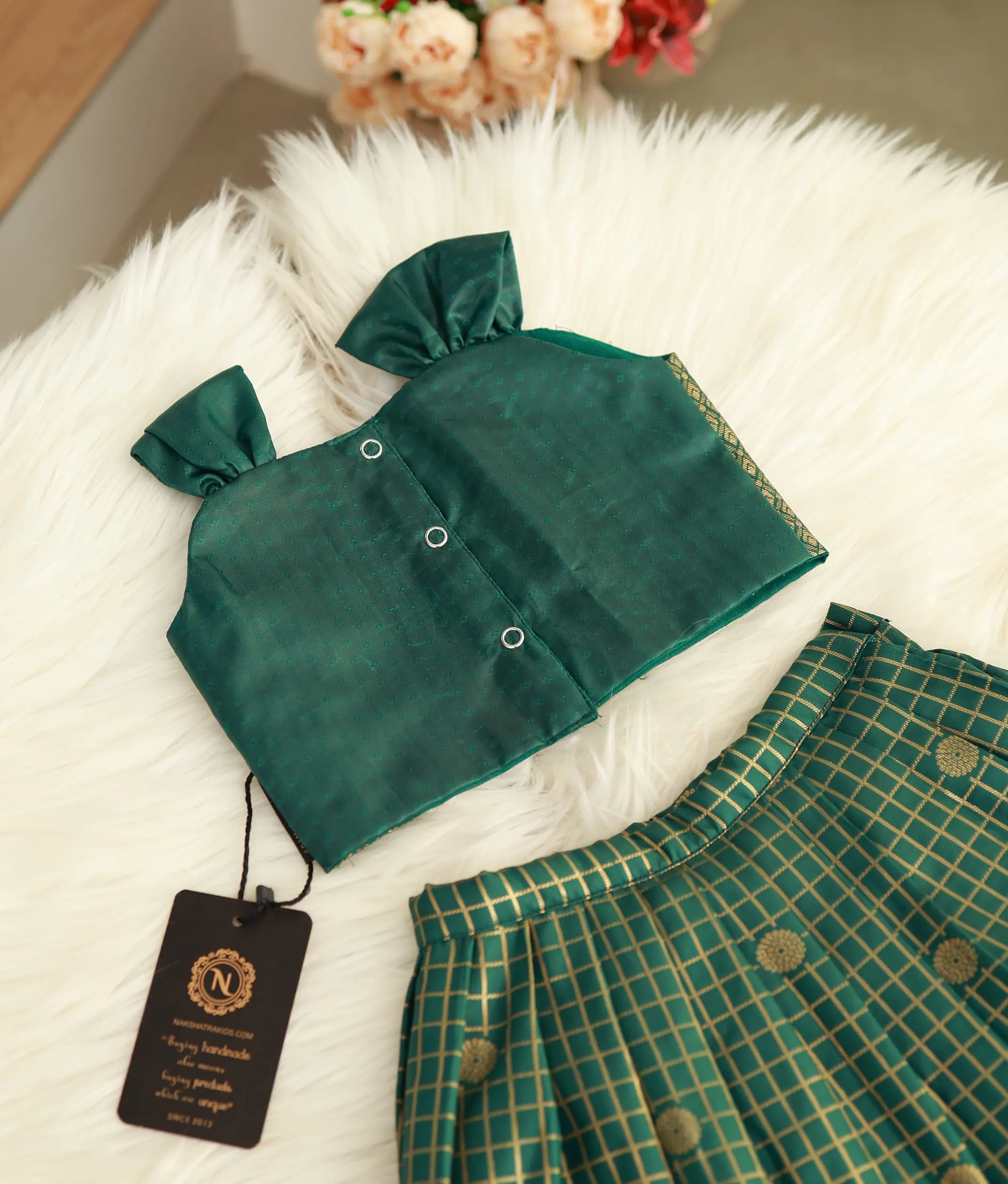 Back view of the emerald green Kanchipuram silk skirt and top showing the press-button closures.