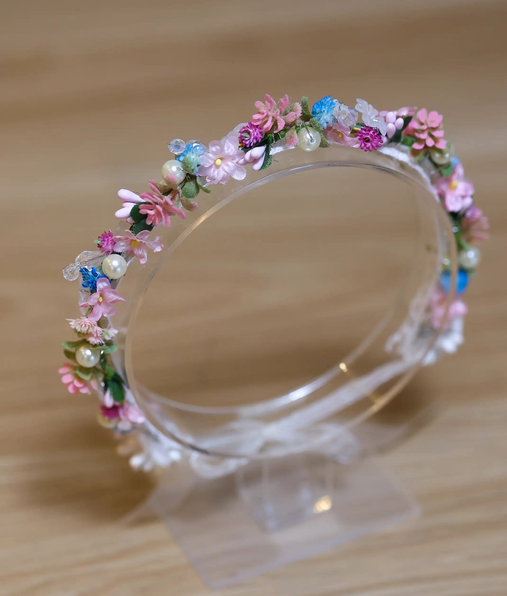 Close-up of the handcrafted multi color flowers and crystal bead detailing on the floral birthday crown