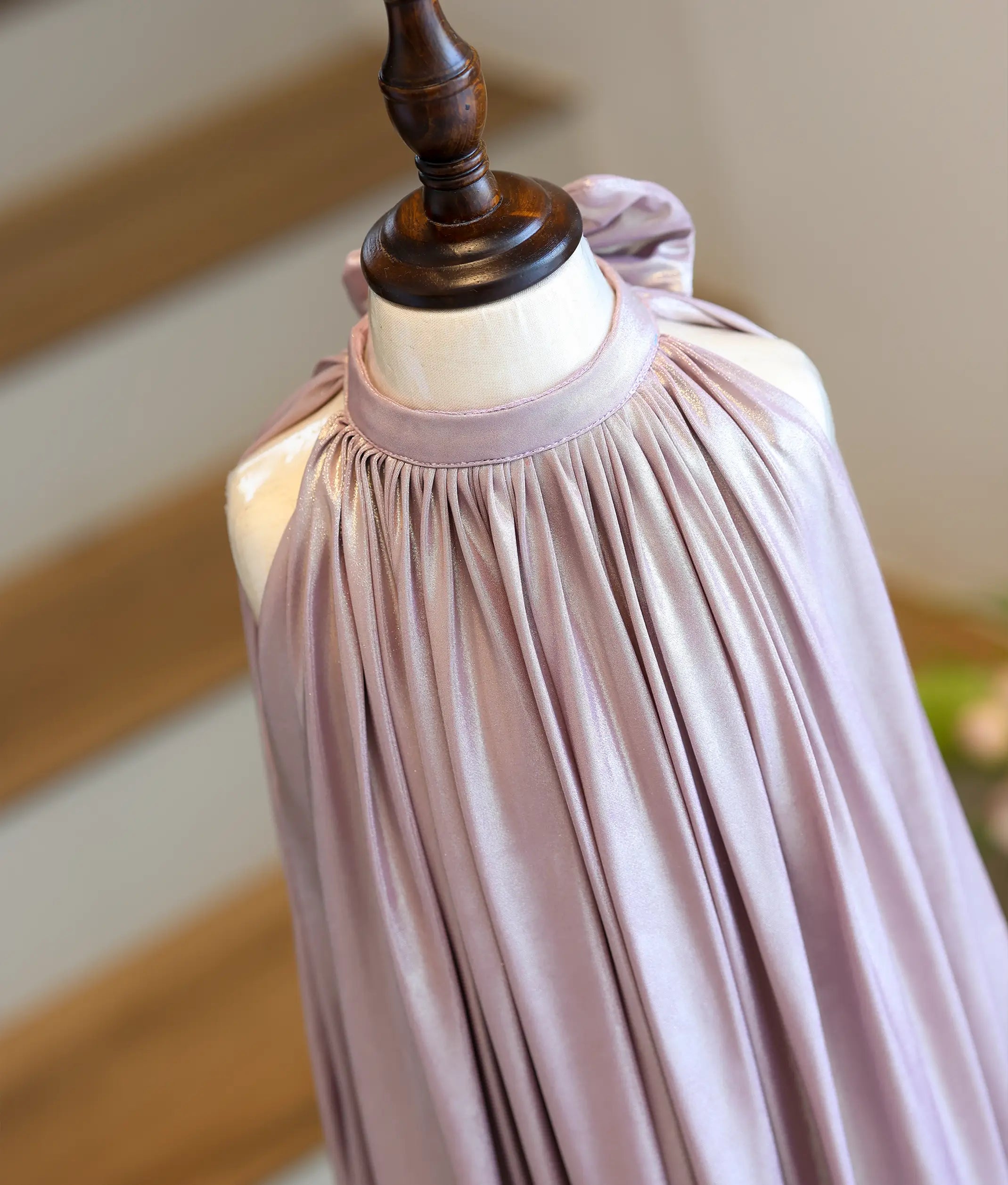 Close-up showing the sunray pleating and shimmering crinkle texture of the lycra fabric.