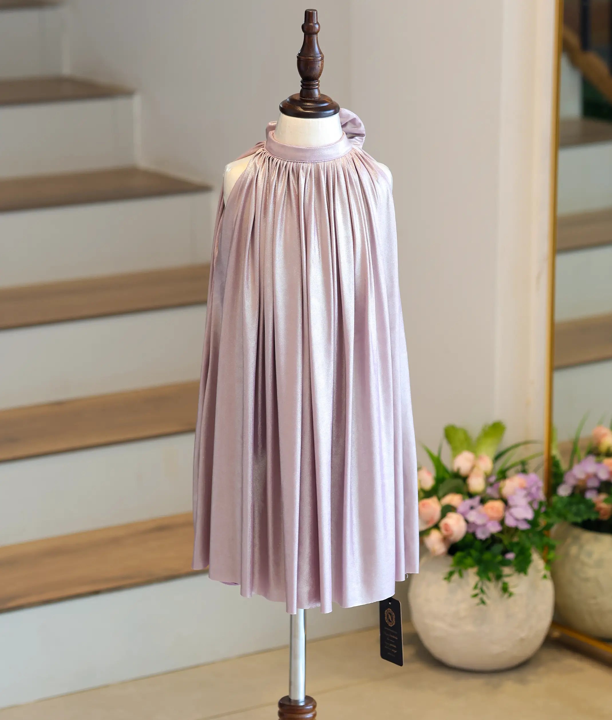 Front view of a girl's frosted lavender shimmer lycra frock with a high neck and wide circular flare.
