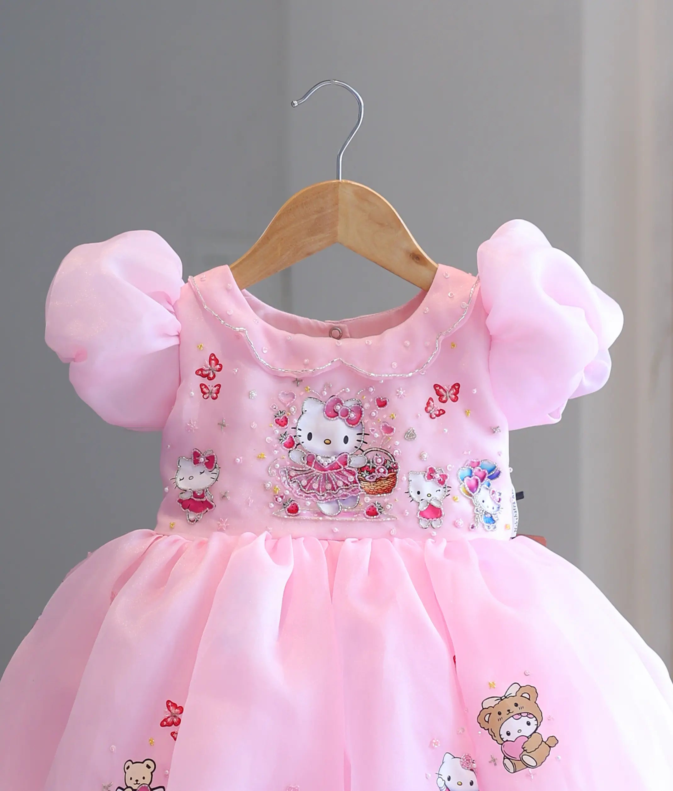 Close-up view of top featuring Hello Kitty print with handworked bead, sequin, and pearl embellishments.