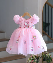 Front view of baby pink shimmer organza Hello Kitty theme frock on hanger display.