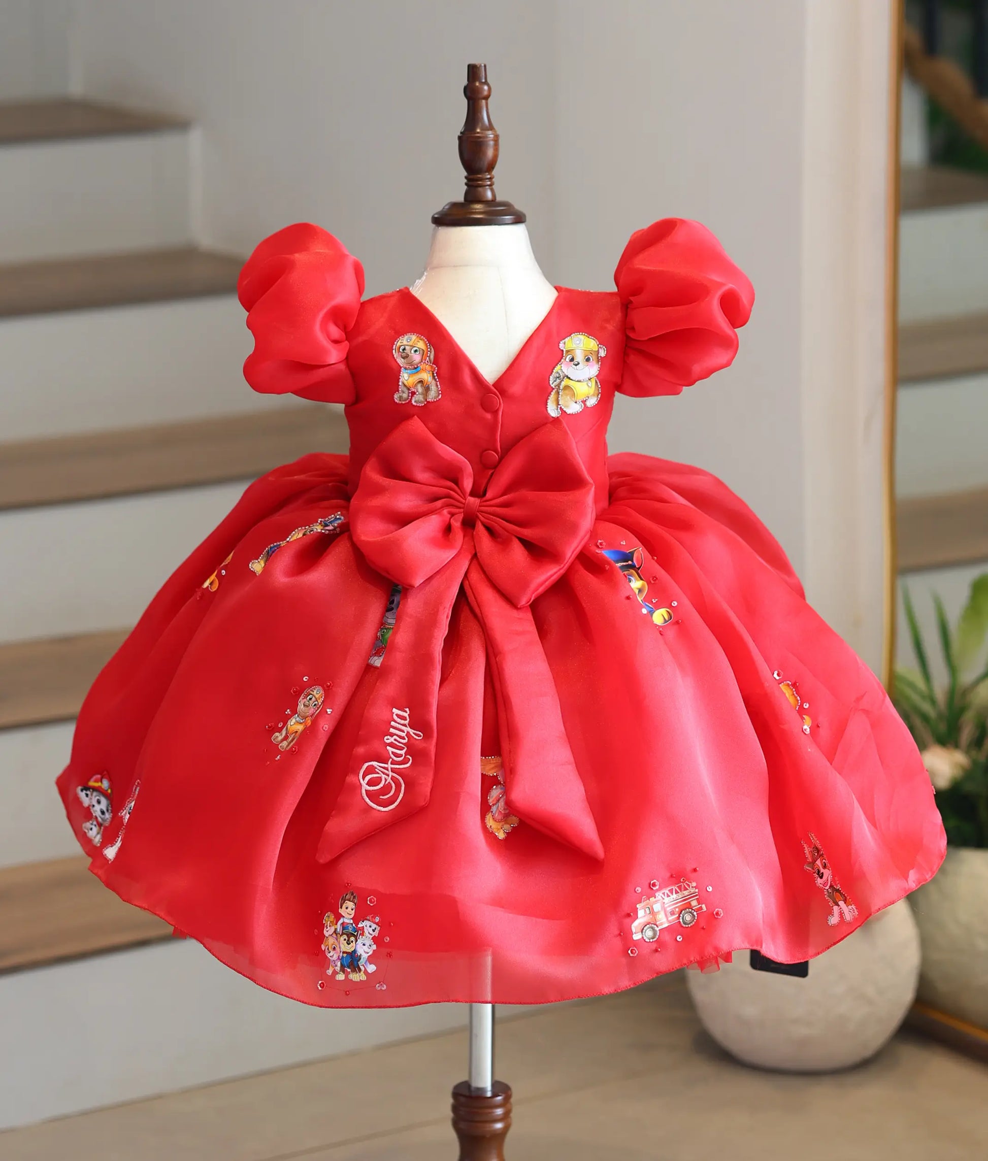 Full back view of the red organza Paw Patrol theme frock showing the large statement bow and back bodice details.
