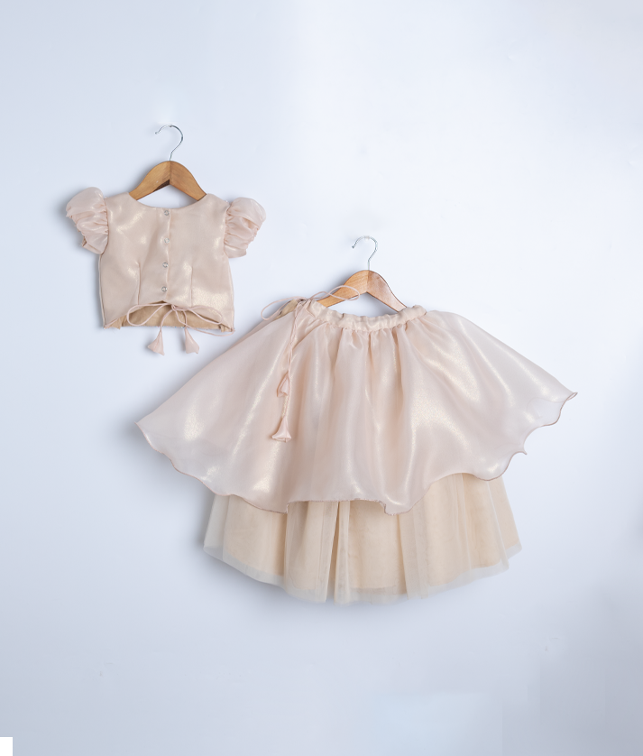 Back view of the golden two-piece set highlighting the round neck with button closure and tie detail