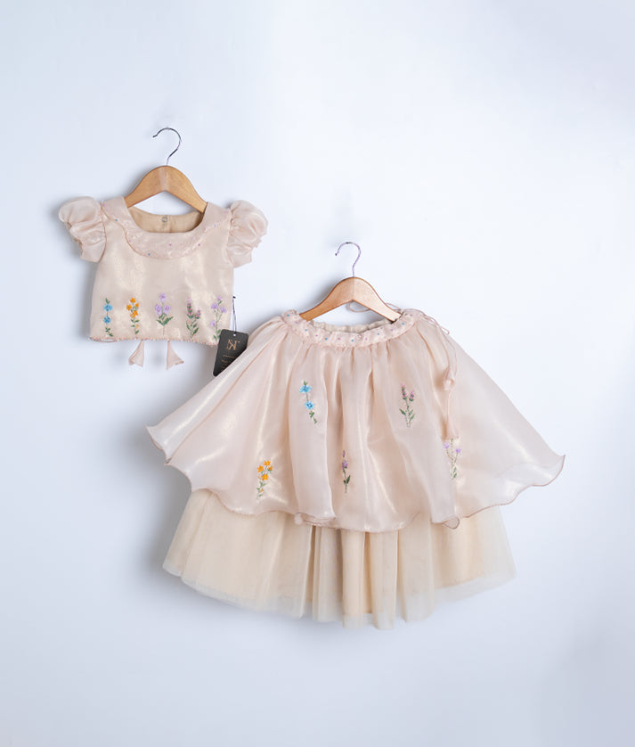 Front view of a golden two-piece western outfit for girls featuring a floral embroidered short top and full skirt