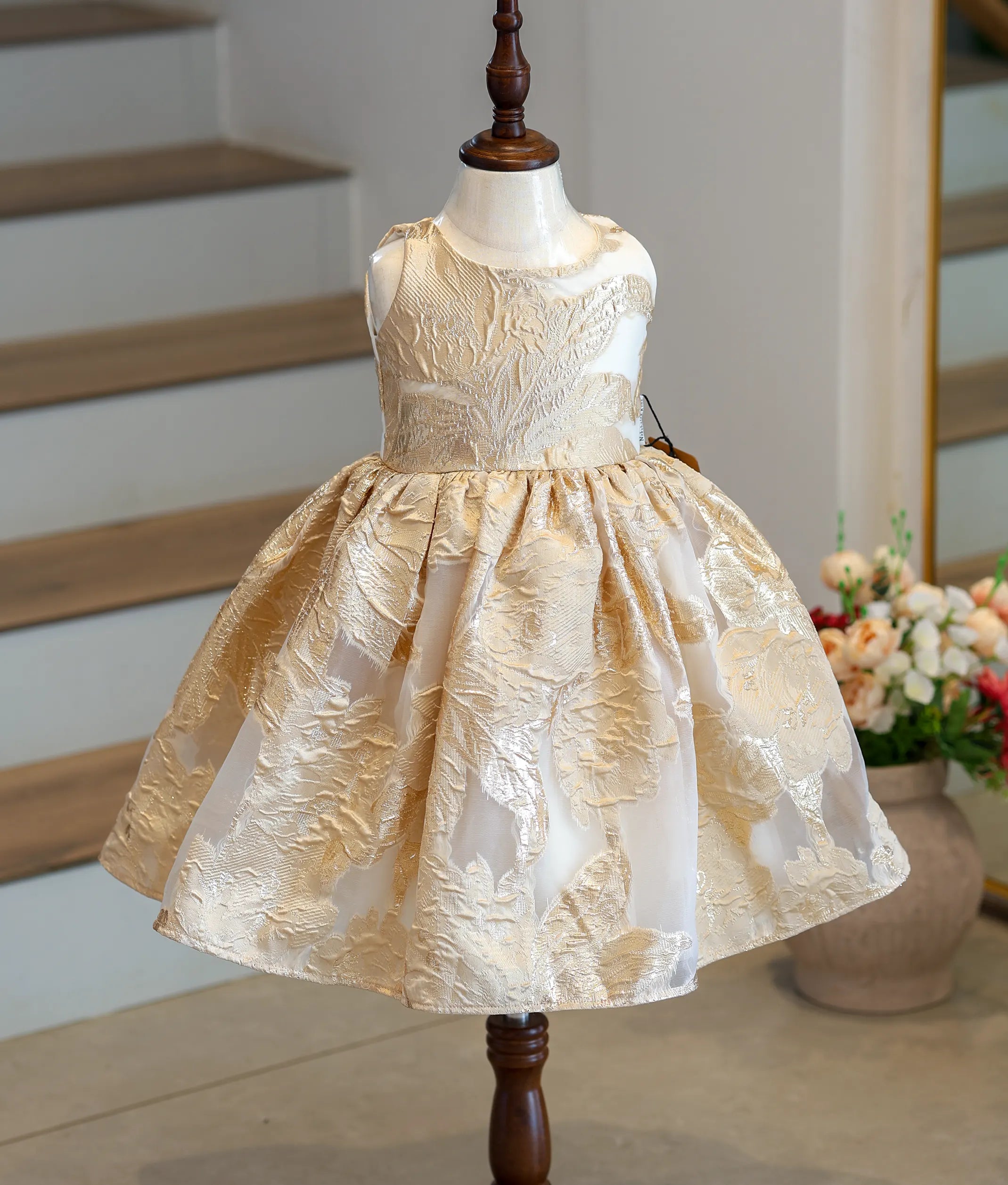 Front view of a golden Turkish organza frock with a floral pattern.