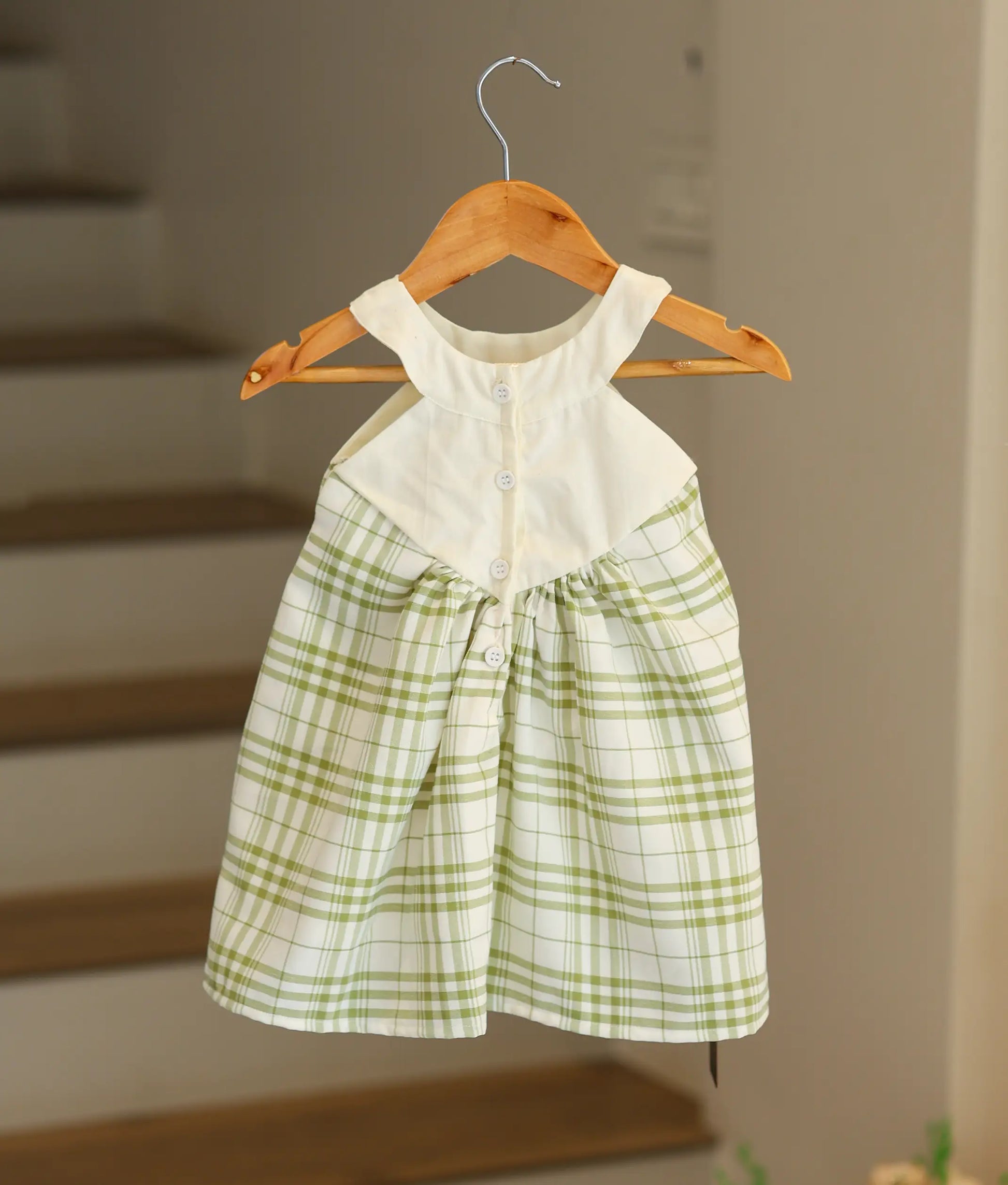 Back view of the green check Christmas frock showing the white bodice and shirt button closure.