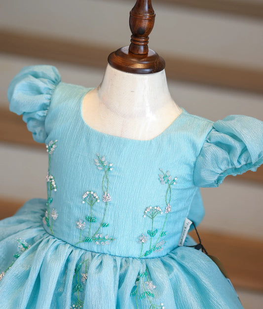 Close-up of the green vine handwork, pearls, and beads on the crush organza bodice.