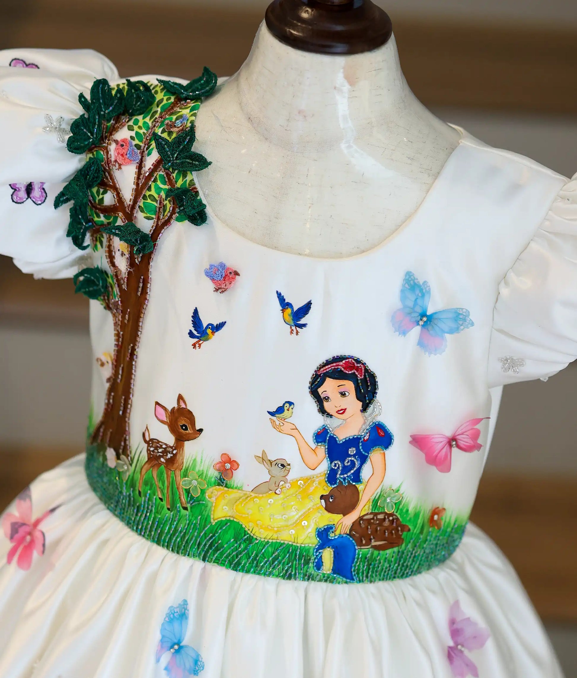 Close-up of the top showing the details of paintings and handwork of the Disney princess theme on the yoke.