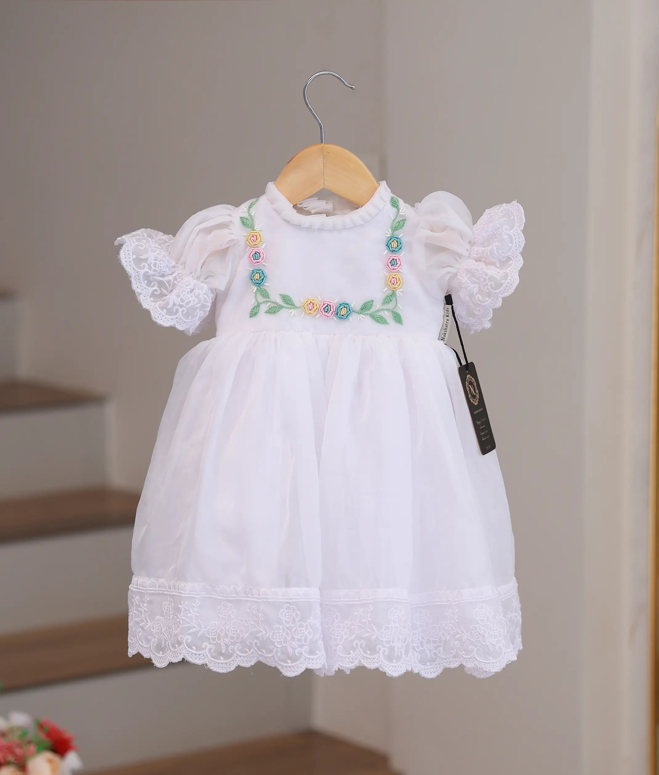 Front view of handworked baptism frock for baby girls in off-white with premium lace and pearl embroidery.