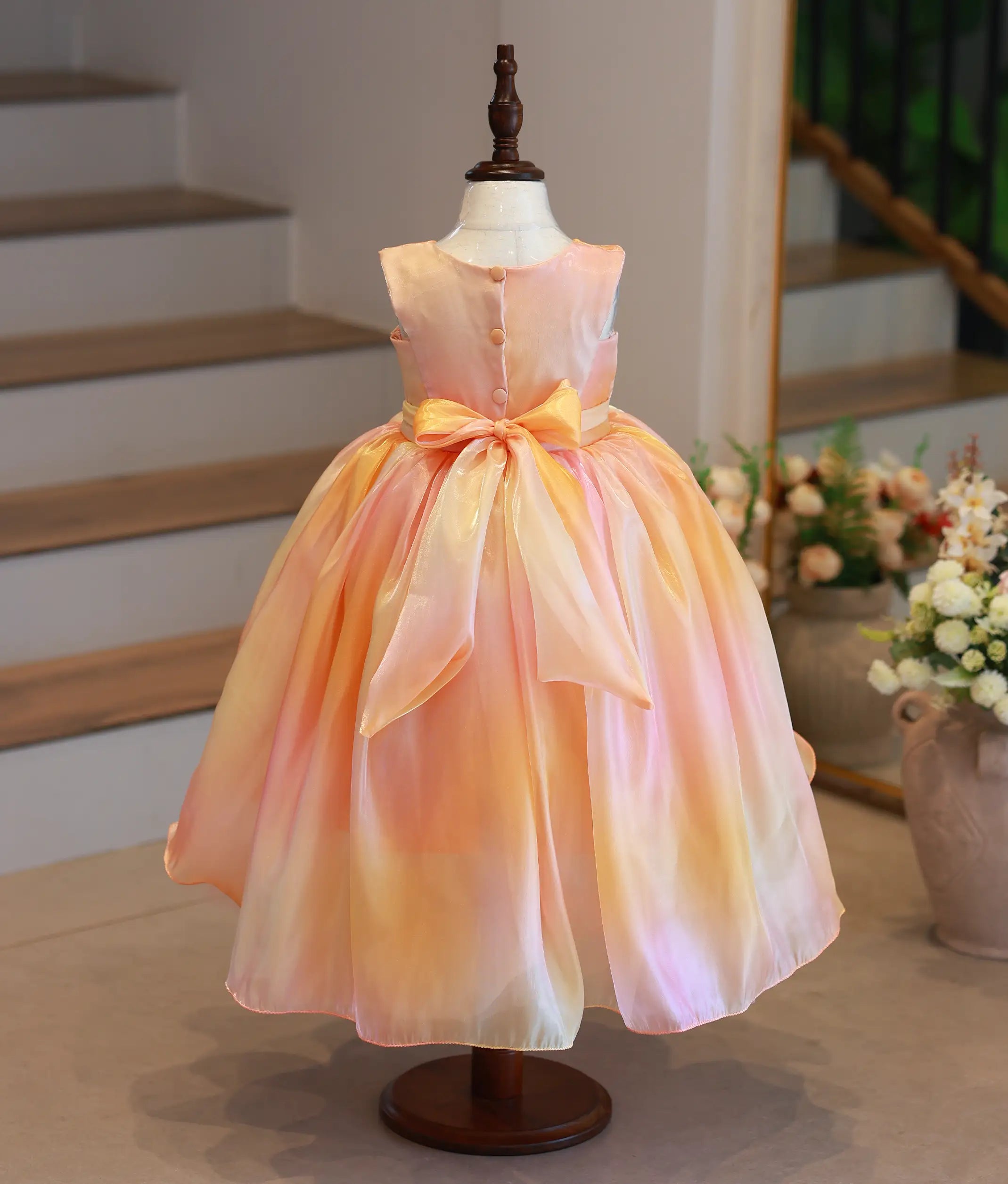 Back view of high-low birthday frock showing the elegant matching sash and long back tail
