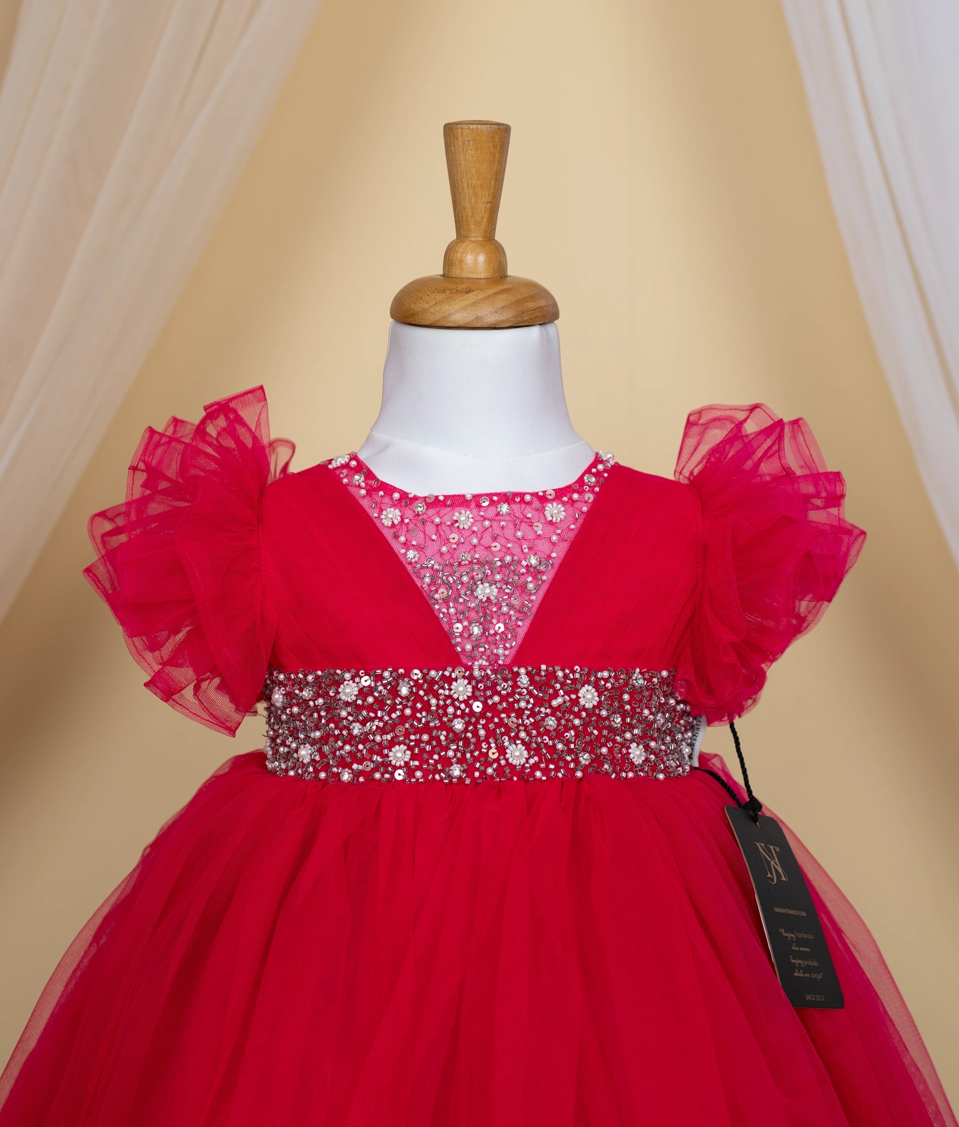 Close-up of the glittering sequin and pearl handwork on the hot pink bodice and the butterfly sleeve detail.