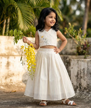 Baby girl wearing ethnic kerala kasavu striped skirt and top for vishu festival.