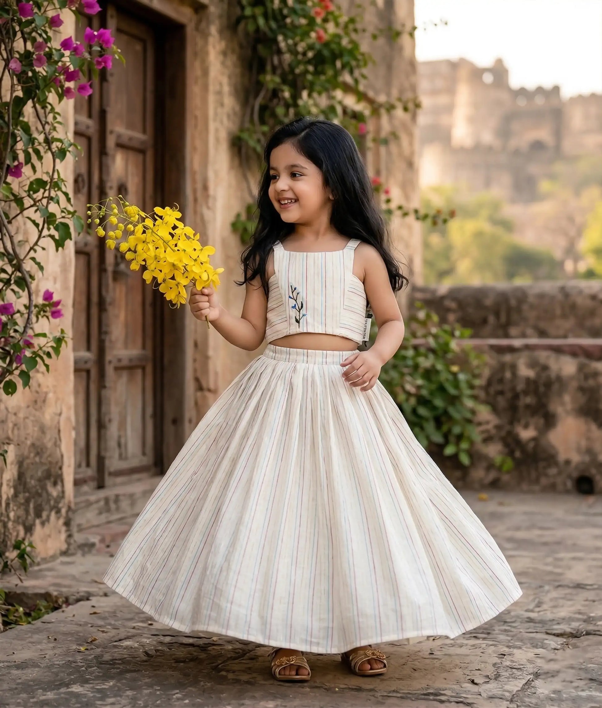 Baby girl wearing an ethnic-style skirt and top, which is best for festivals like onam and vishu.