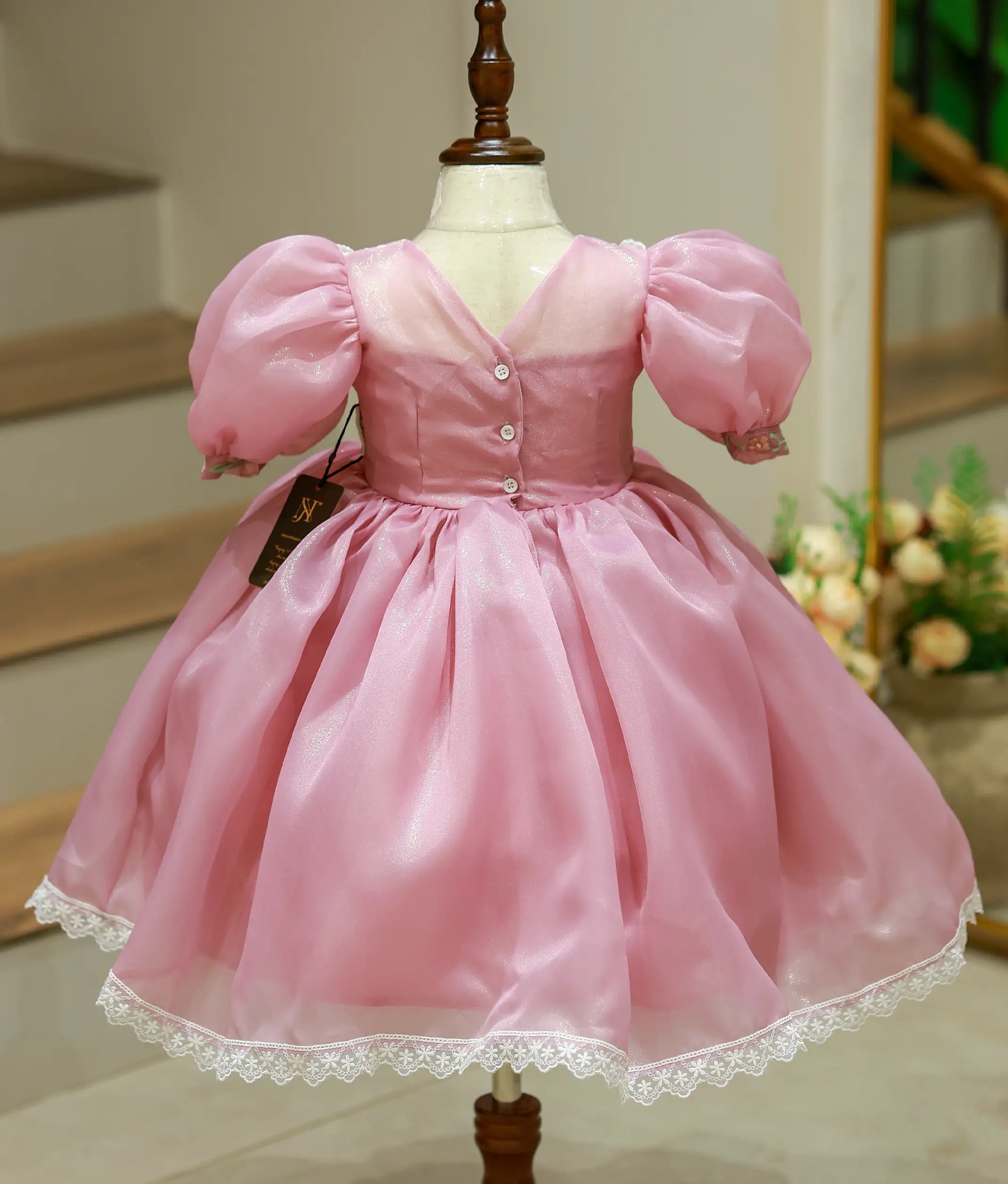 Back view of pastel lavender frock showing the V-neck button closure and voluminous flared skirt
