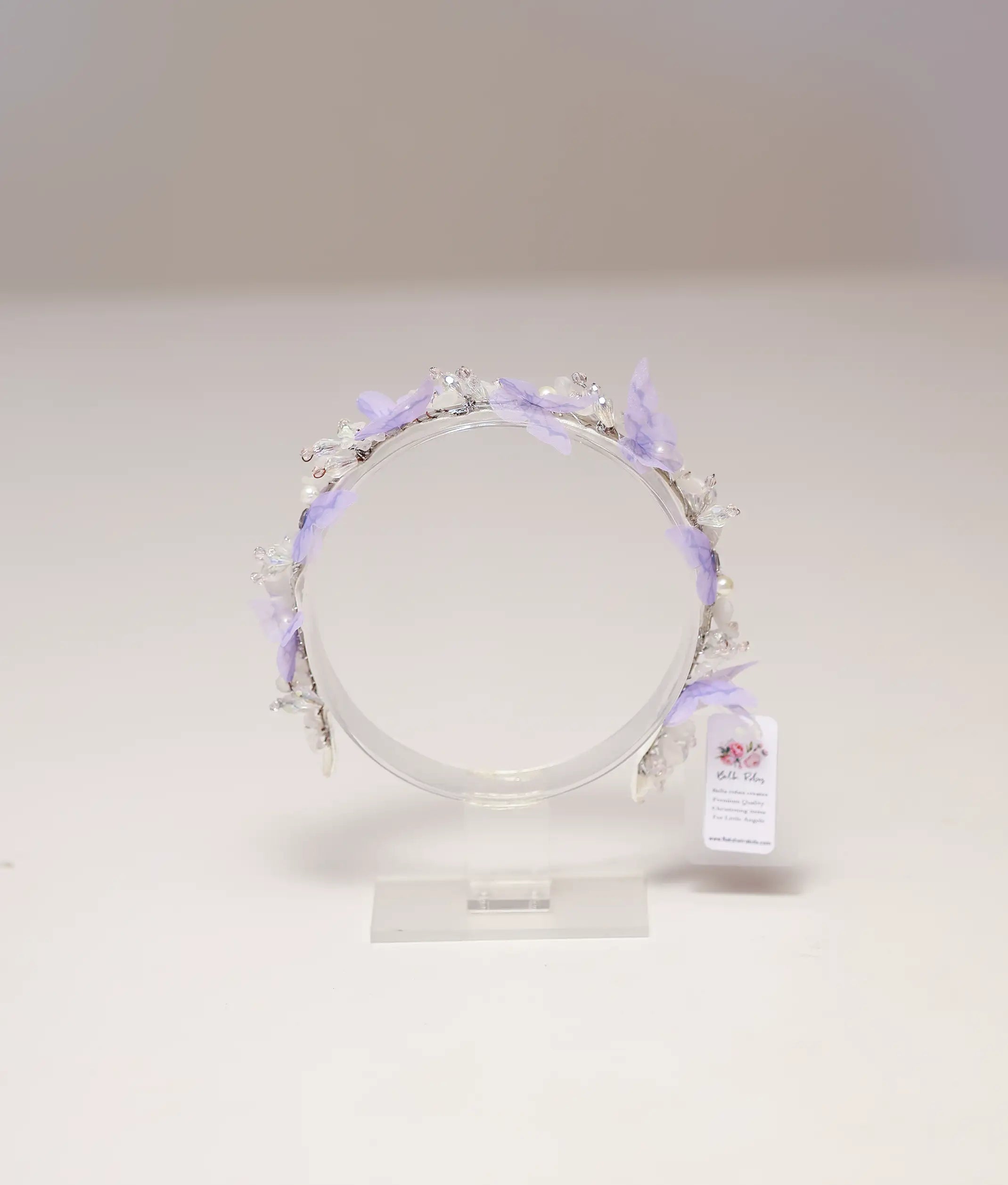 Front view of a lavender butterfly and pearl handmade tiara for girls on a silver band