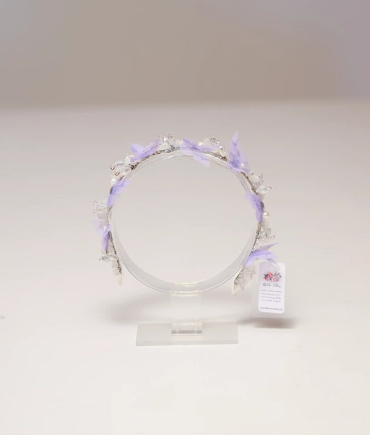 Front view of a lavender butterfly and pearl handmade tiara for girls on a silver band