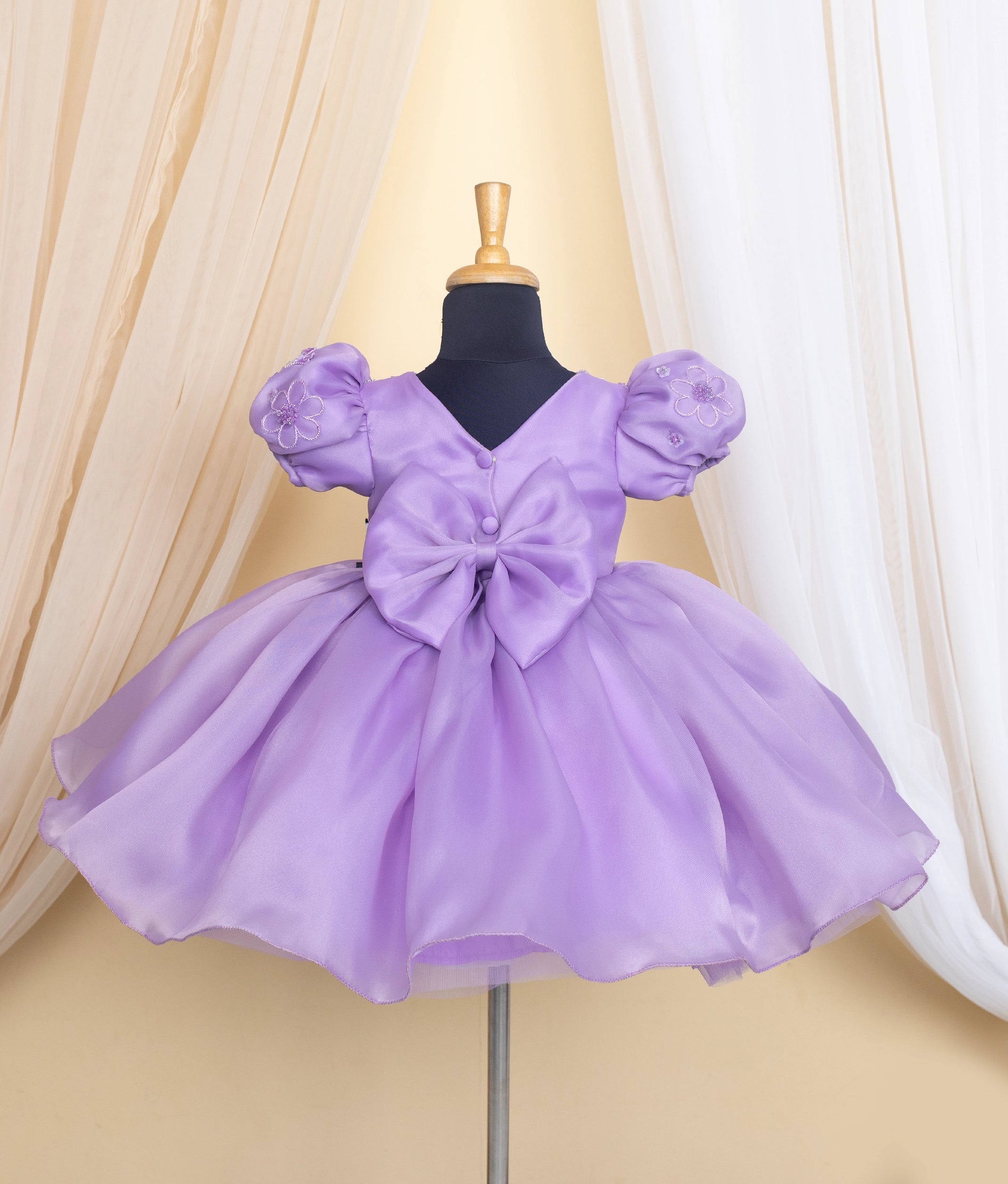 Back view of the lavender flower theme dress showing the elegant V-neck and simple show button closure