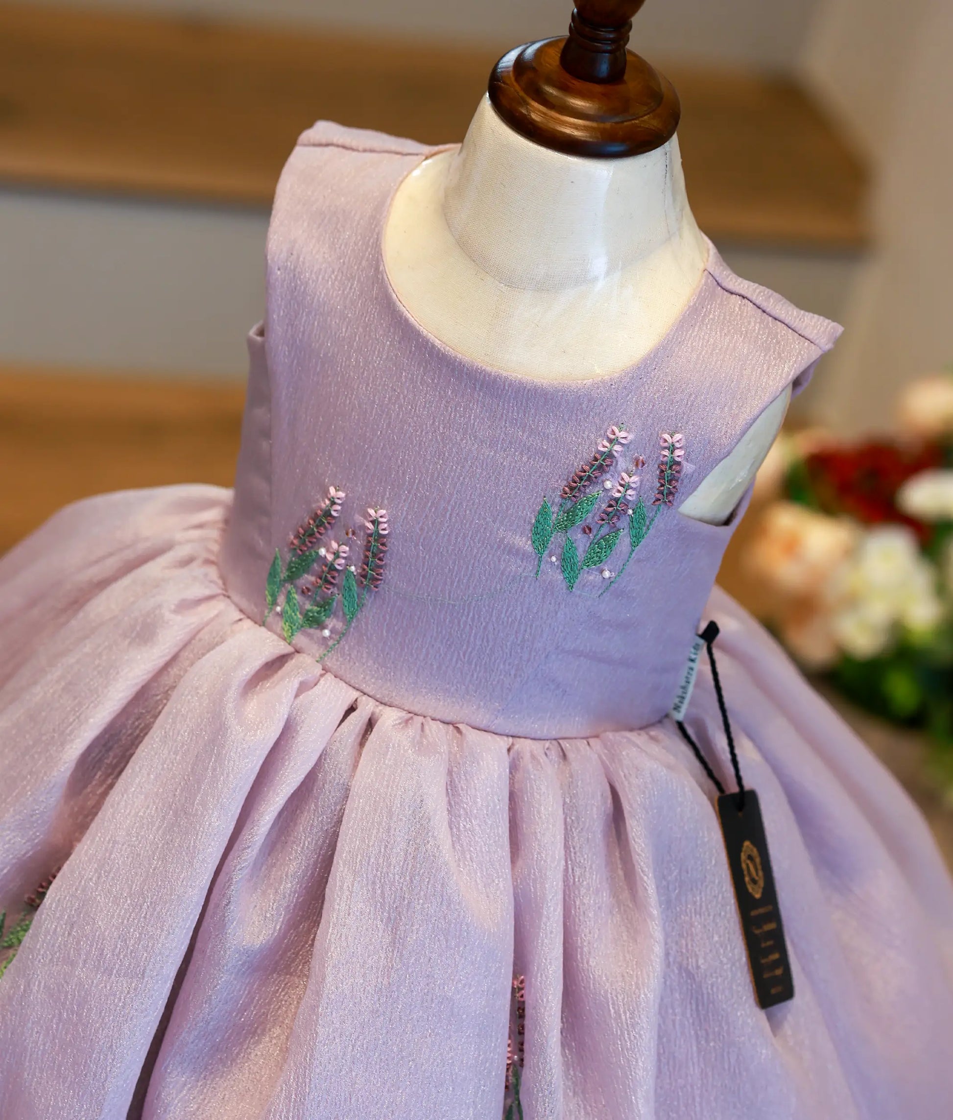 Close-up of the delicate floral-vine embroidery and handworked yoke on the shimmering lavender crush organza birthday dress