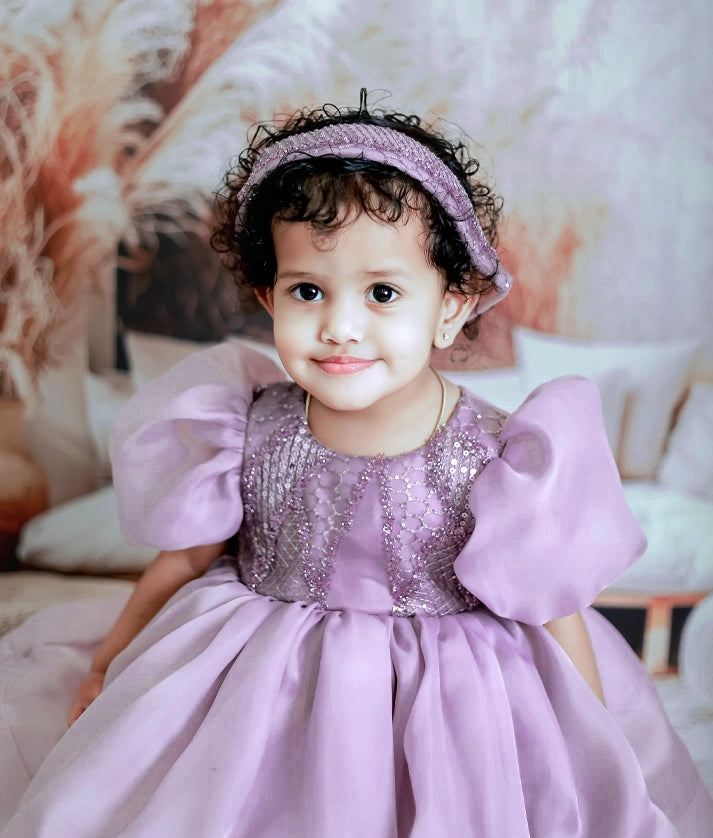 Close-up of the fancy worked yoke material and stylish balloon sleeves on the pastel lavender birthday frock
