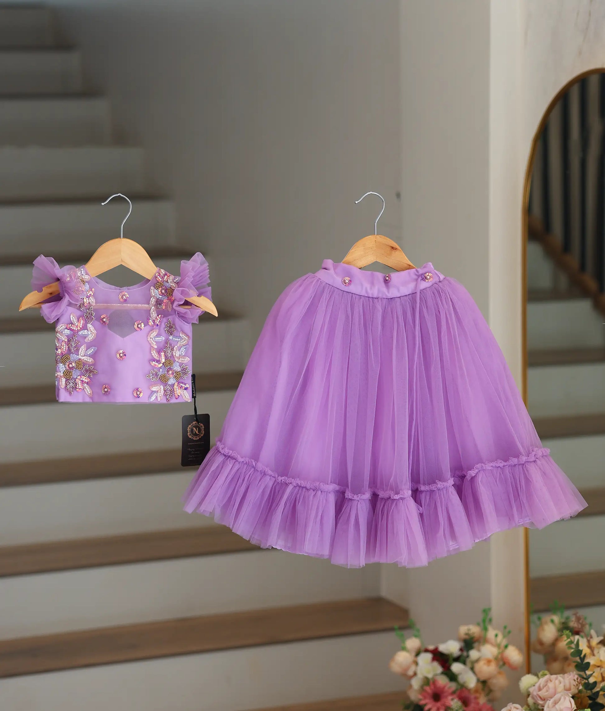 Front view of a lavender handworked crop top and full-length ruffled tulle skirt for baby girls