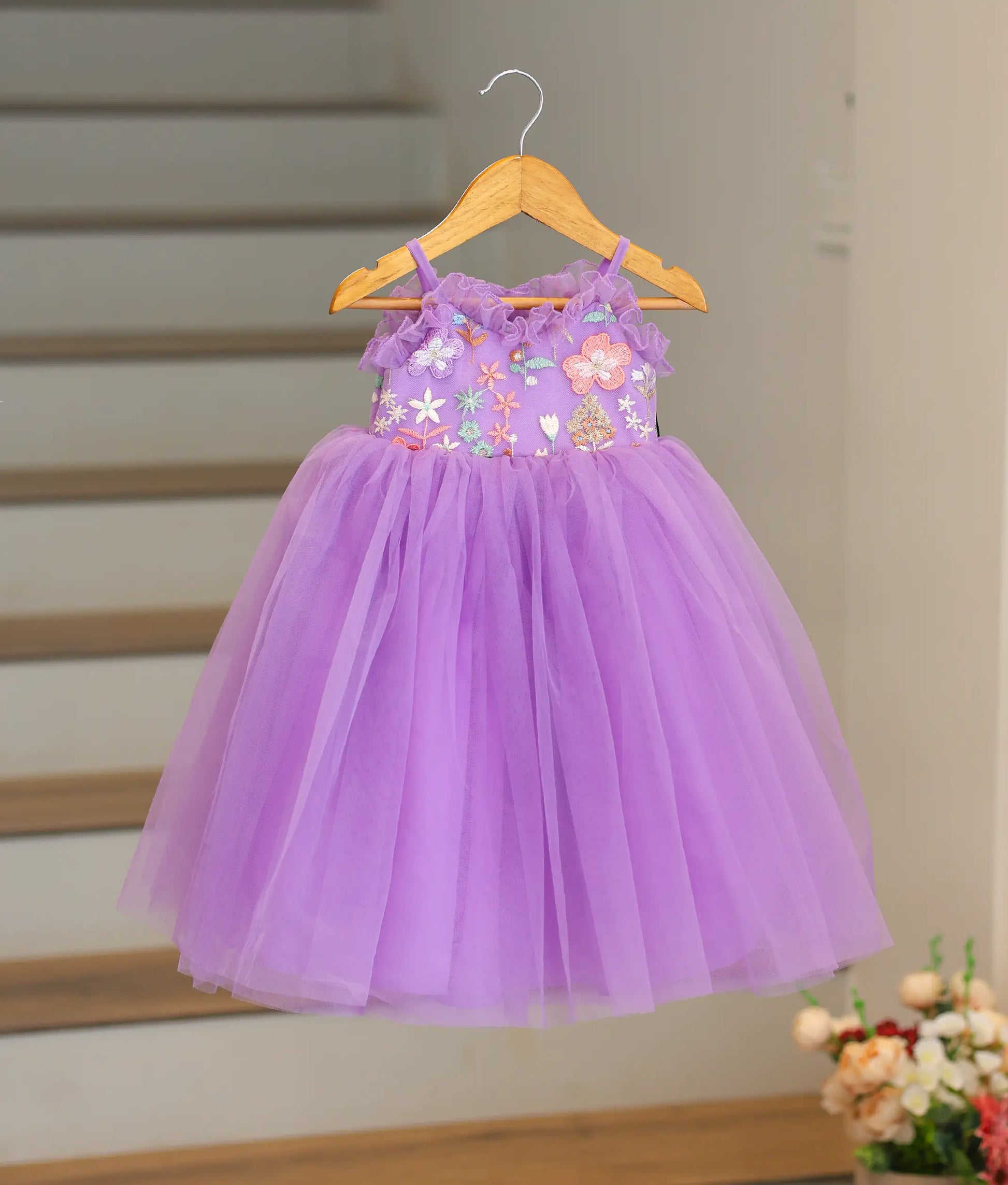 Front view of a lavender handworked organza birthday frock for baby girls with floral sequin designs