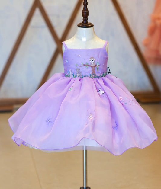 Front view of a lavender organza jungle-themed birthday frock for baby girls with fawn embroidery and butterfly details
