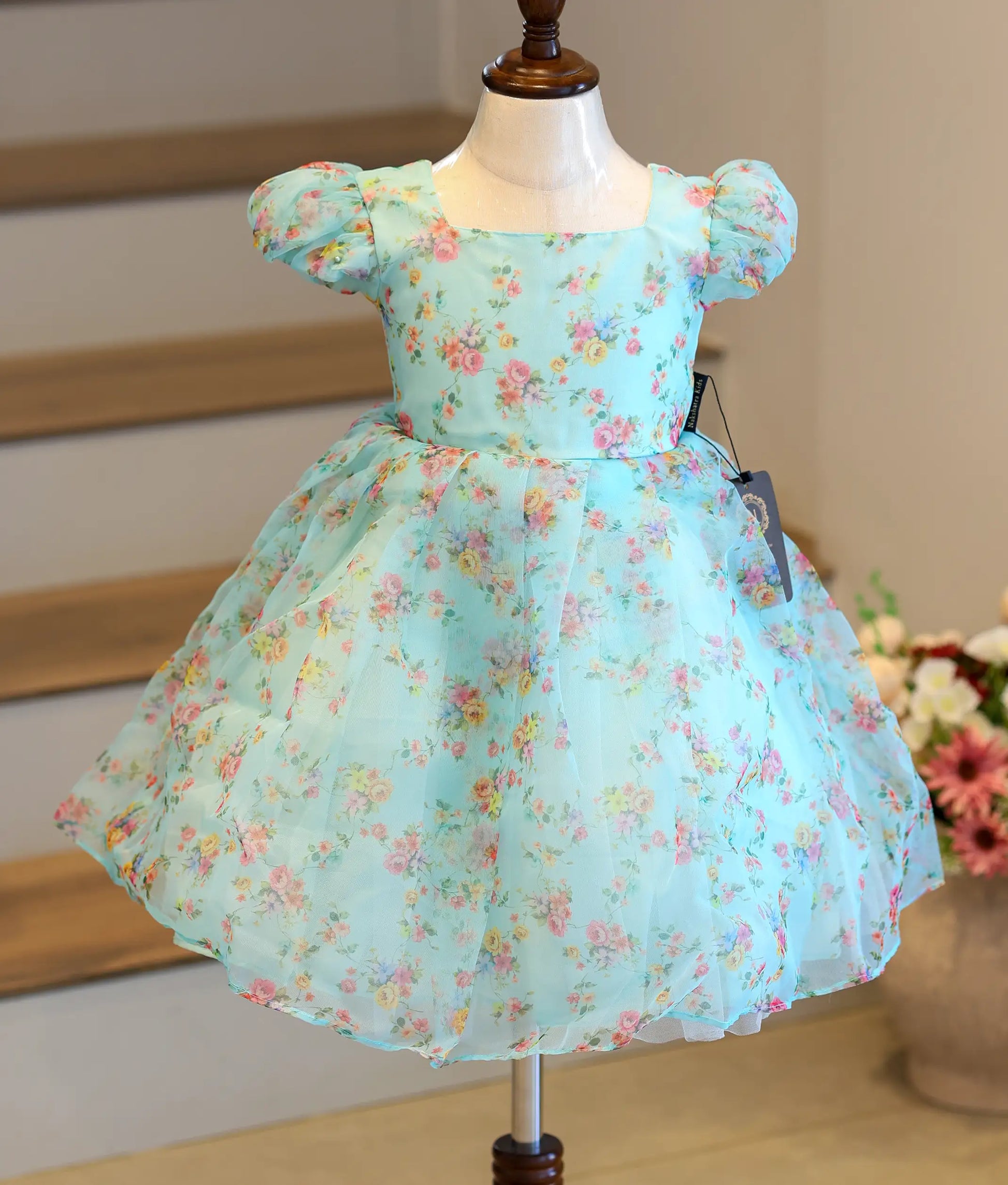 Front view of a light blue floral printed organza casual frock for baby girls