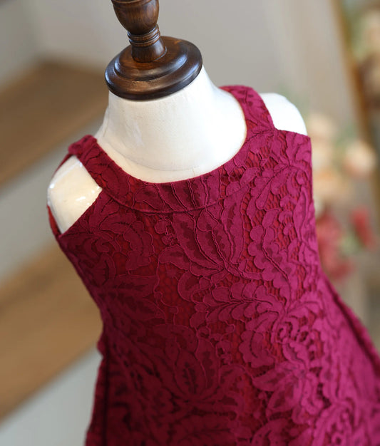 Close-up showing the intricate floral corded lace detailing on the maroon frock.