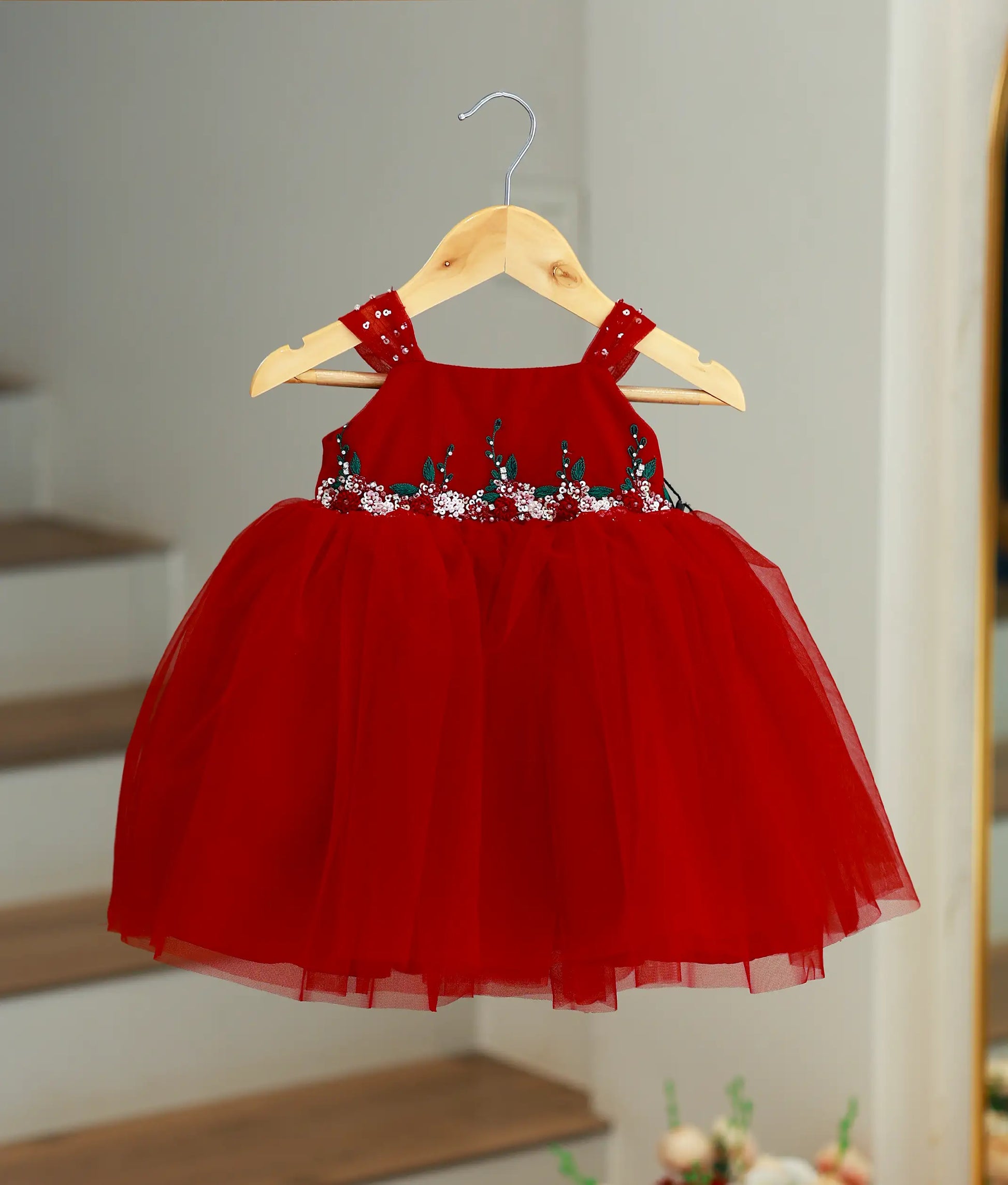 Red net party wear frock for baby girls featuring a fluffy tutu skirt and floral sequin handwork.
